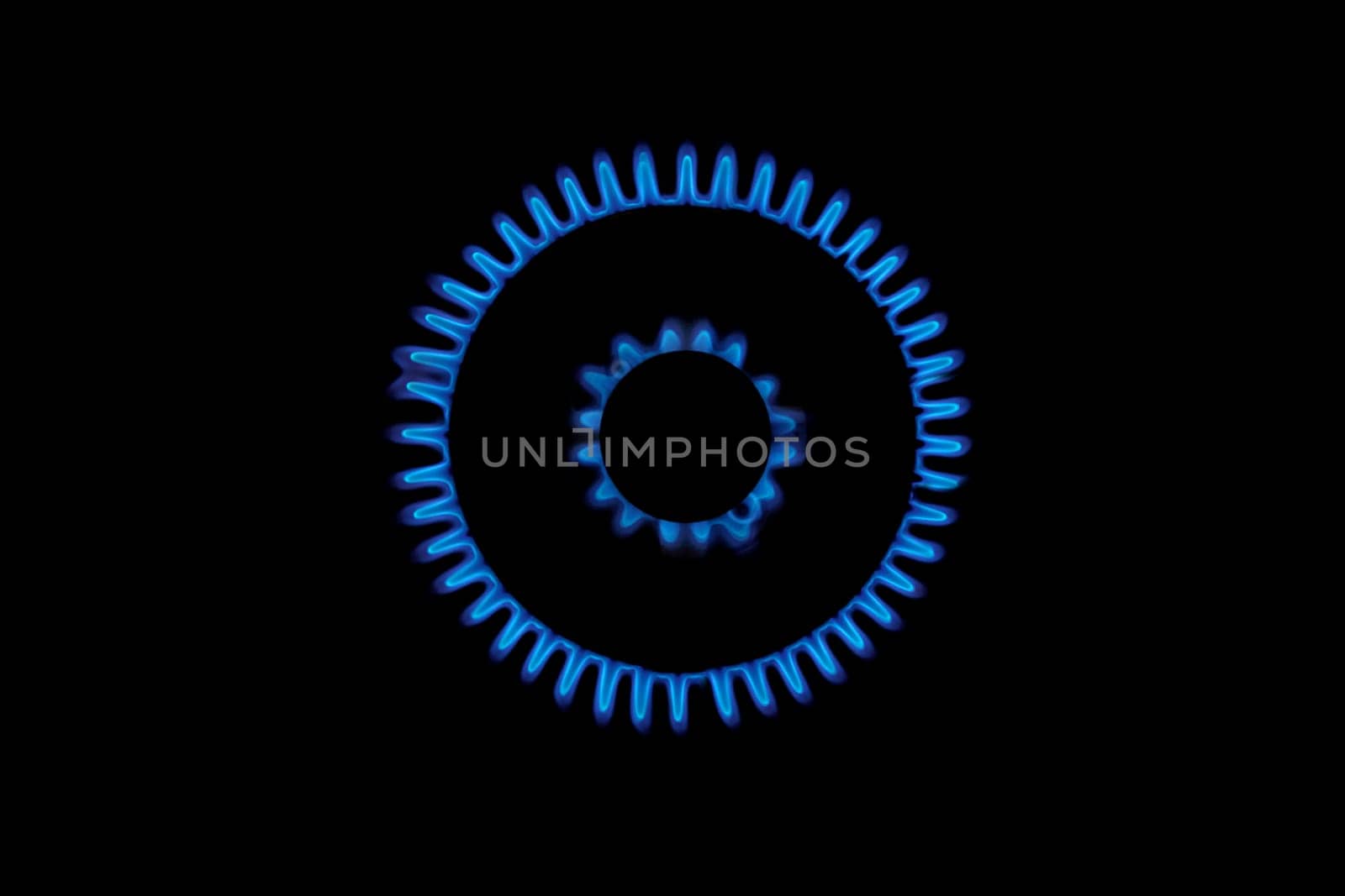 Gas burns blue on black background. Heat and Mirage above the gas hob switched on. Top view of a kitchen burner glowing at night, close-up. Natural gas concept. The gas stove is on by EvgeniyQW