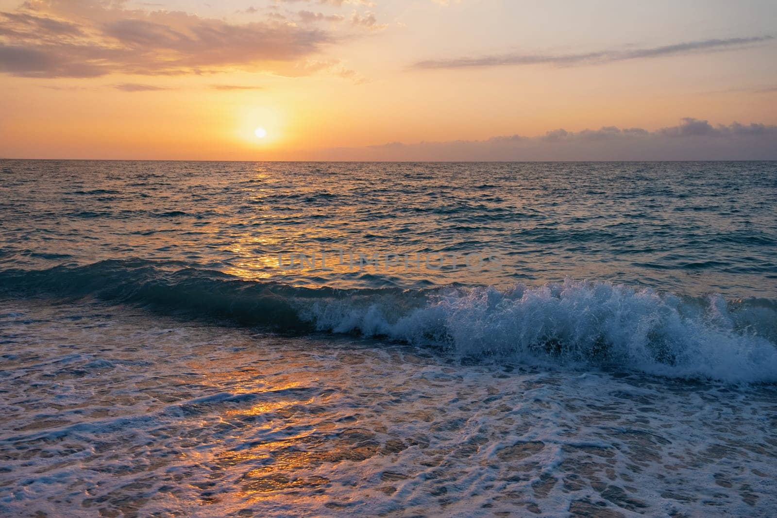 The picturesque sea at sunset. Sunset on the Black Sea with the sun, Abkhazia. Colorful sunset with waves.