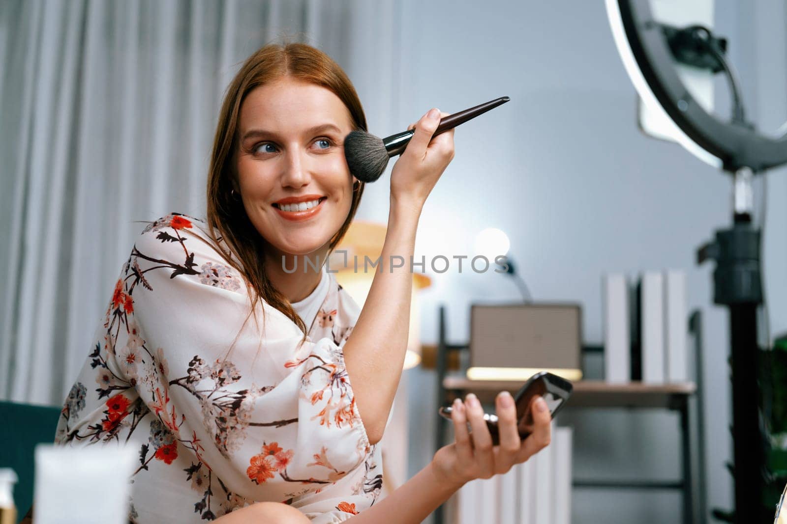 Woman influencer shoot live streaming vlog video review makeup utmost social media or blog. Happy young girl with cosmetics studio lighting for marketing recording session broadcasting online.