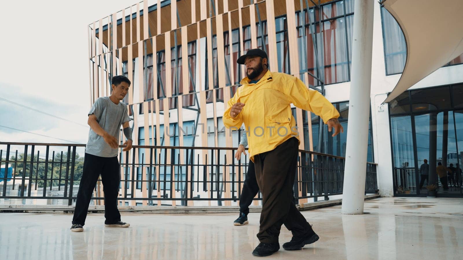 Hip hop team dance break dance while multicultural friend surrounded and clapping hands to cheer or encourage his friend to dance. Active and energetic street dance. Outdoor sport 2024. Endeavor.