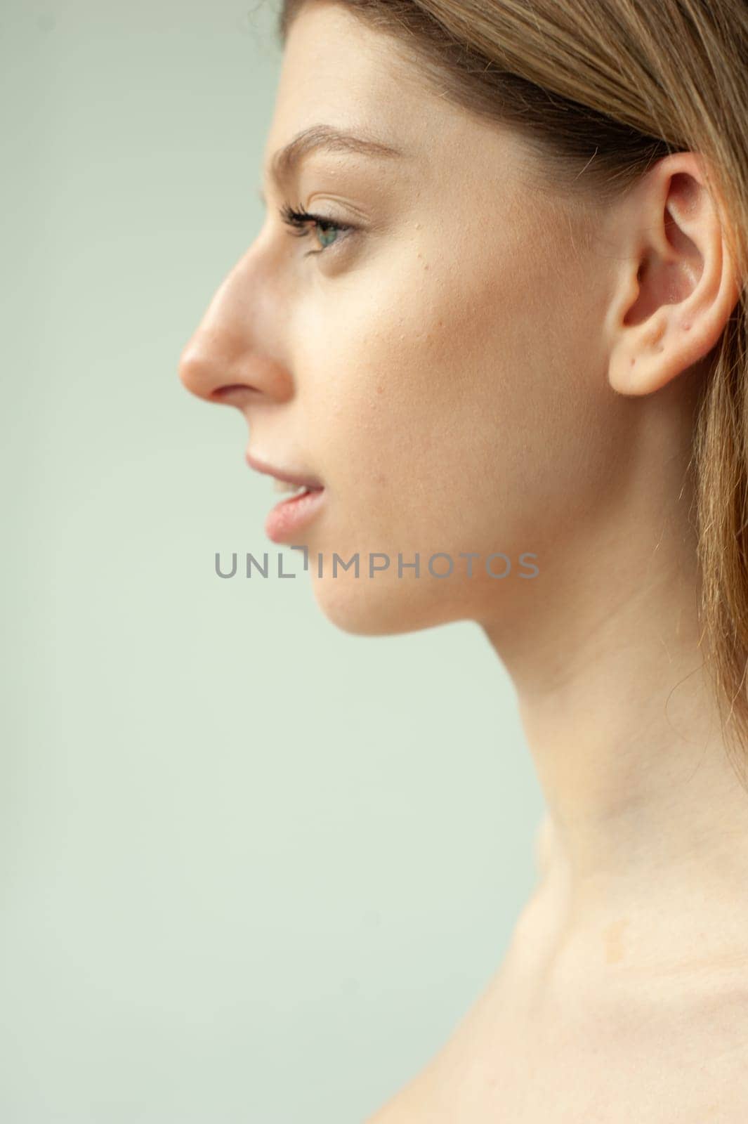 Model test portrait with young beautiful fashion model posing on background.