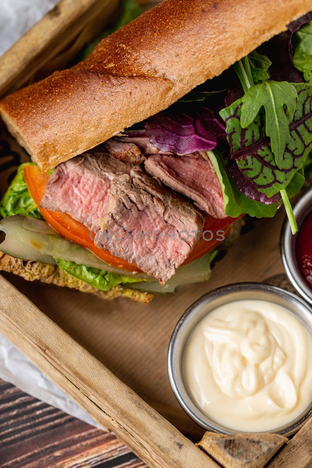 Grilled steak sandwich with french fries on a white porcelain plate