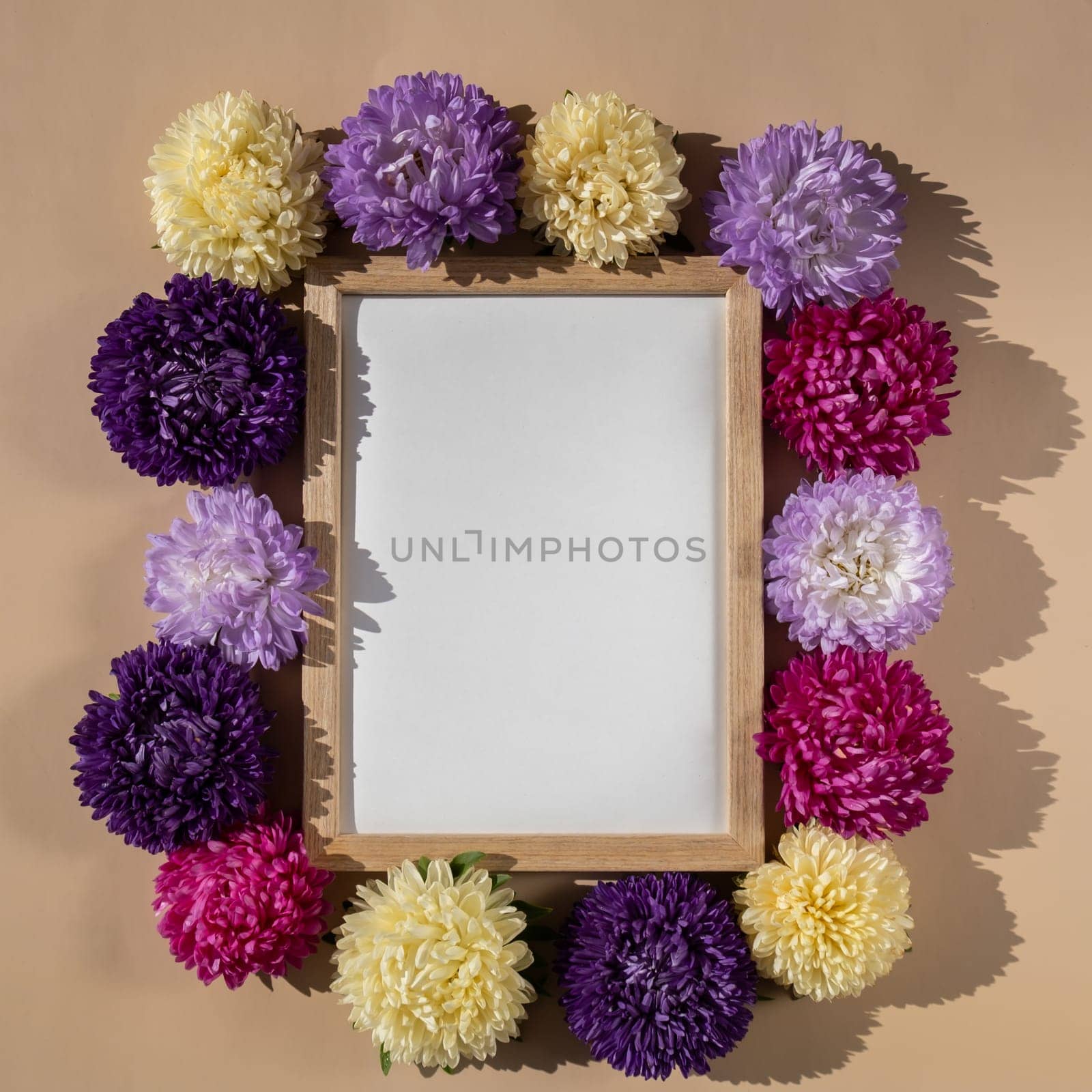 Empty paper frame with copy space for text. Mock up template. Colorful flowers around. Holiday greeting card. Minimalistic spring concept women's day, easter, valentines