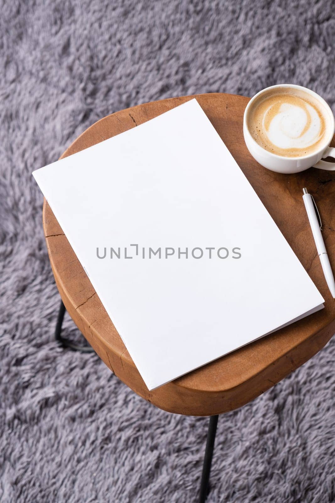 blank magazine mockup on coffee table with cappuccino, pen and grey rug. Template magazine cover