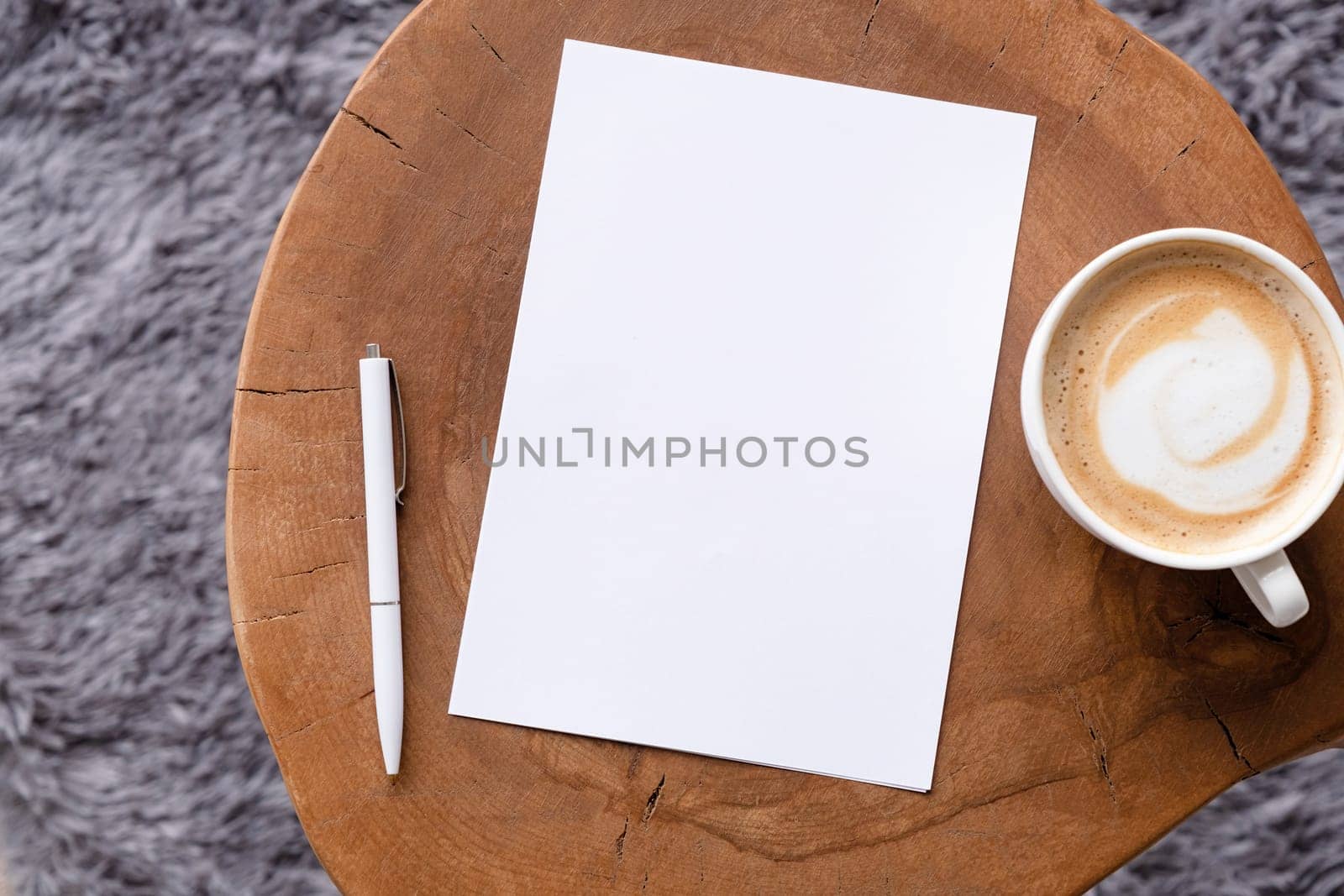blank notepaper mockup on coffee table with cappuccino, pen and grey rug. Template notepaper