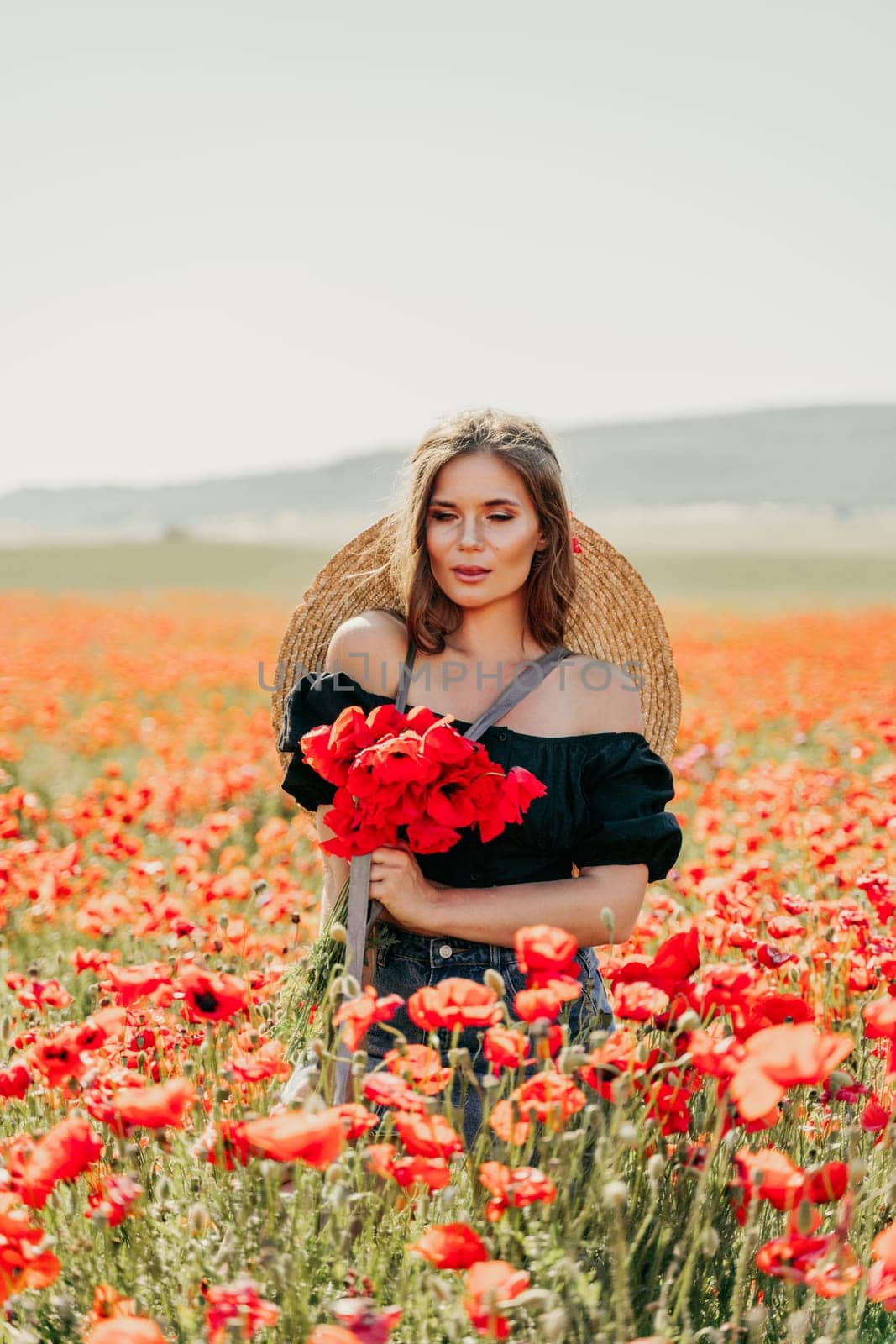 Woman poppies field. portrait happy woman with long hair in a poppy field and enjoying the beauty of nature in a warm summer day. by Matiunina