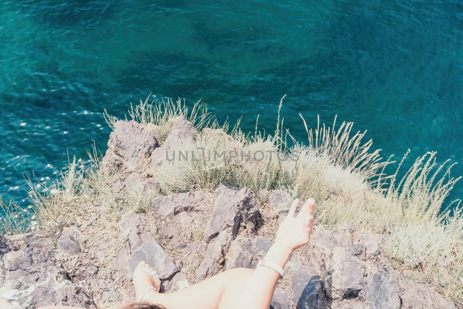 Woman sea yoga. Back view of free calm bliss satisfied woman with long hair standing on top rock with yoga position against of sky by the sea. Healthy lifestyle outdoors in nature, fitness concept. by panophotograph