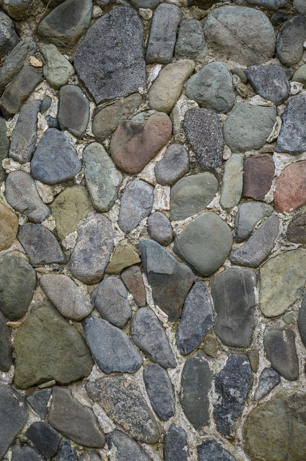 wall of a house made of sea stones as a background texture by Mixa74