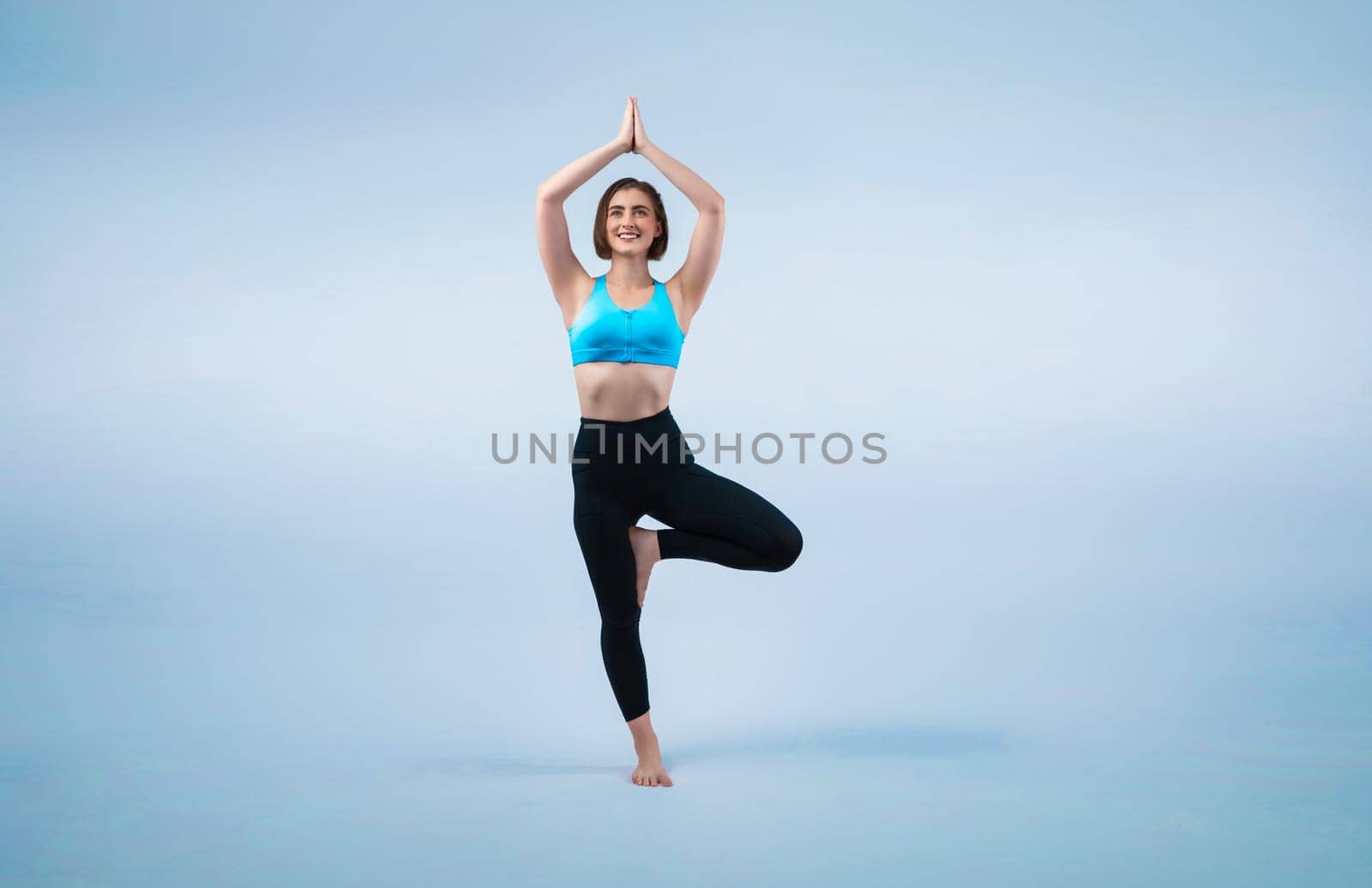 Full body length gaiety shot athletic and sporty woman doing healthy and meditative yoga exercise workout posture on isolated background. Healthy active and body care lifestyle