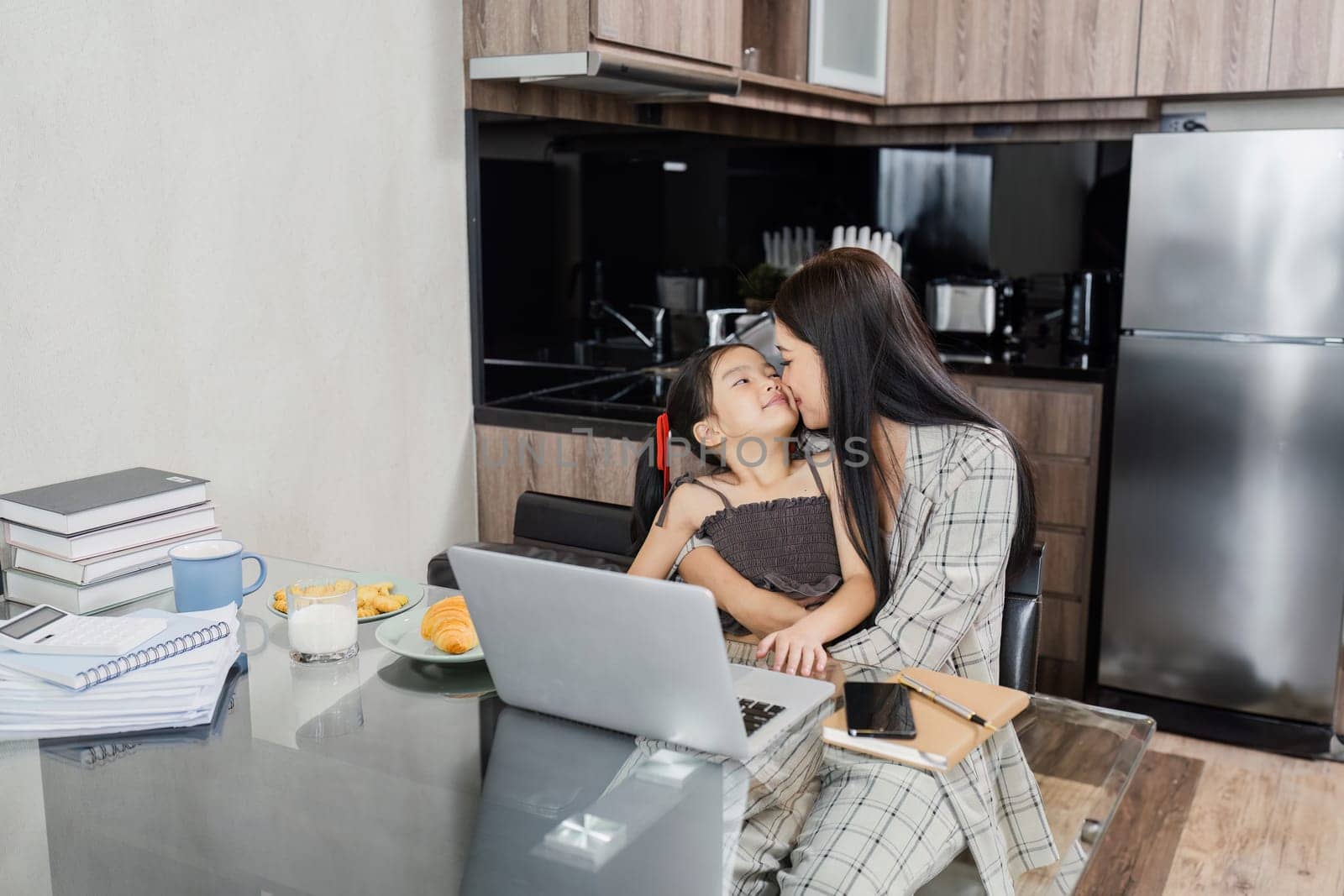 business woman work from home and take care of her child while working by itchaznong