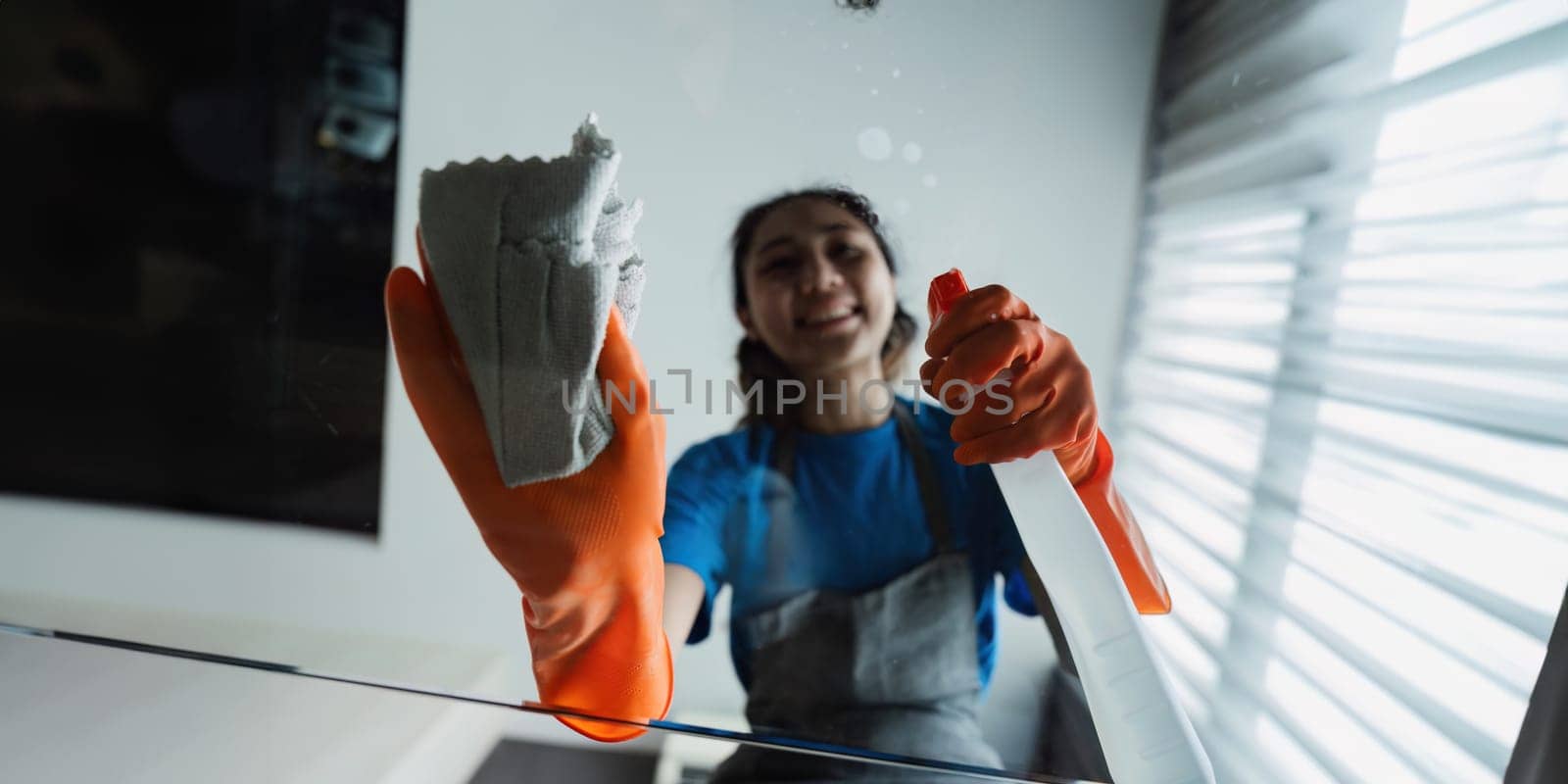 Housekeeping woman wiping the table in the living room House cleaning service concept.