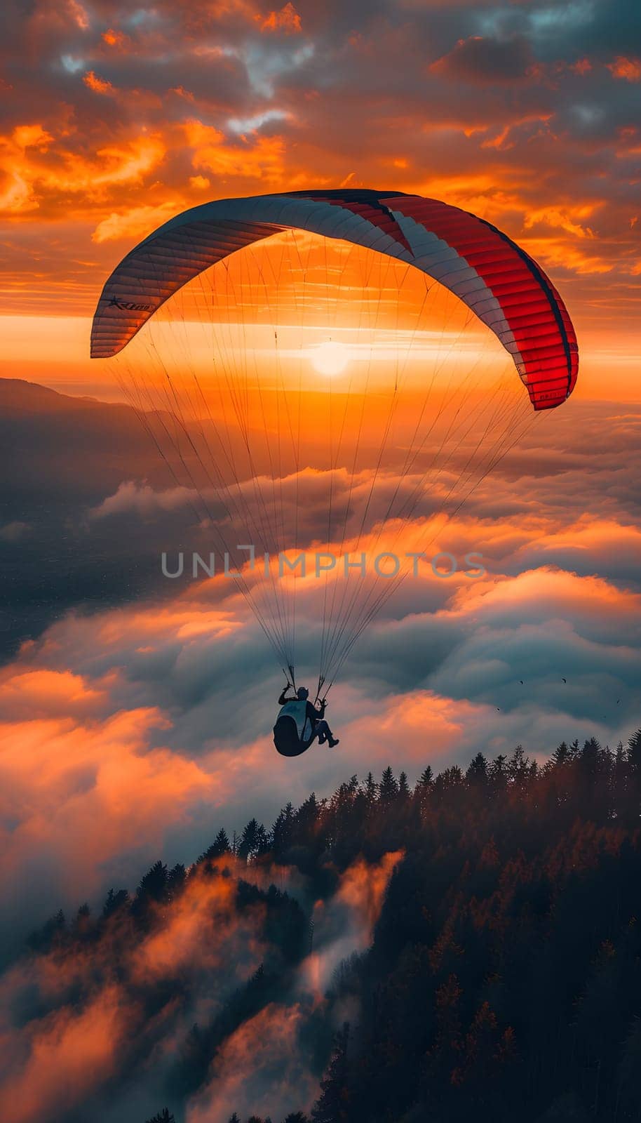 A person is parasailing at sunset over a mountain, surrounded by orange hues and a peaceful atmosphere in the natural landscape
