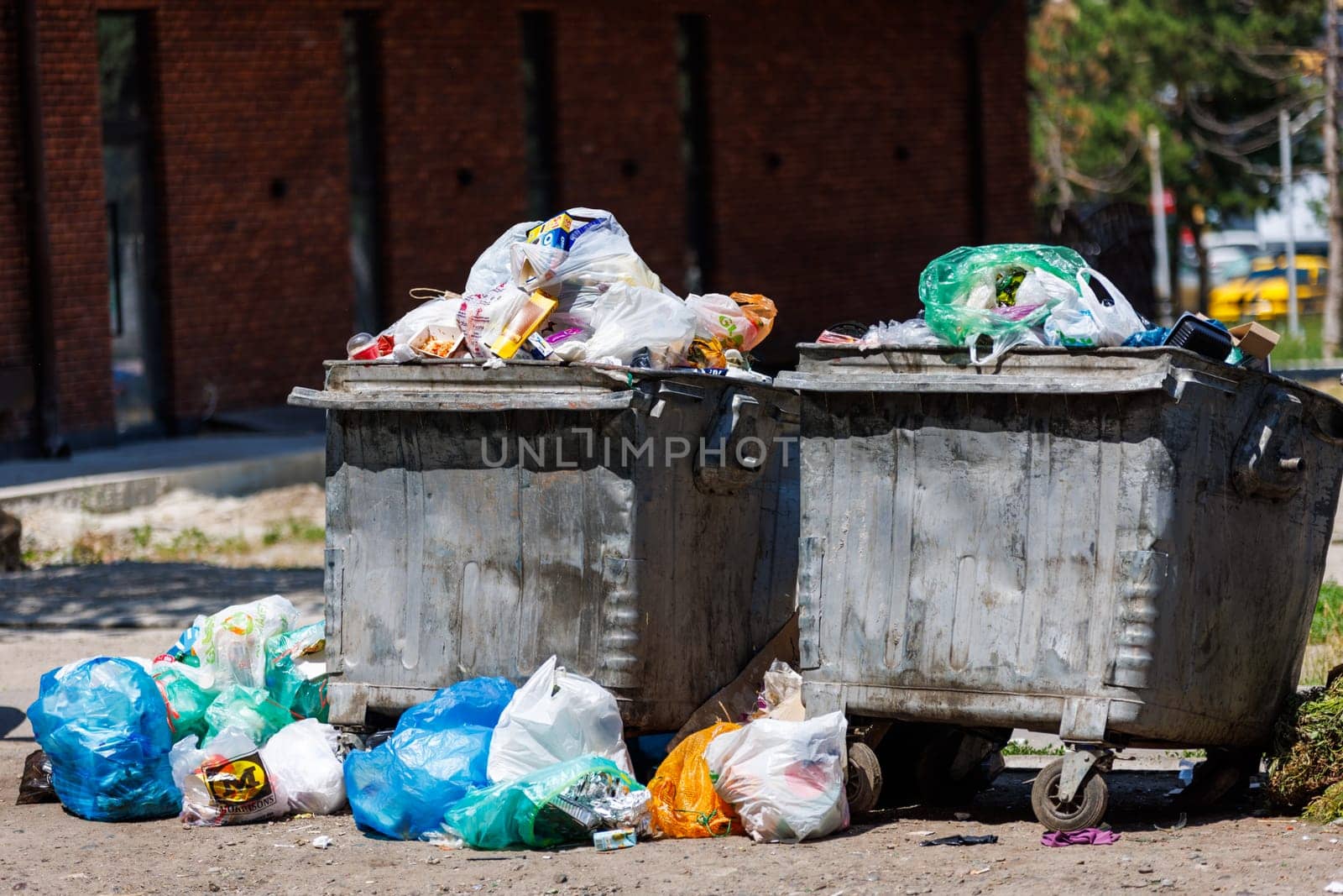 overfilled public trash bins at summer day in Bishkek, Kyrgyzstan by z1b