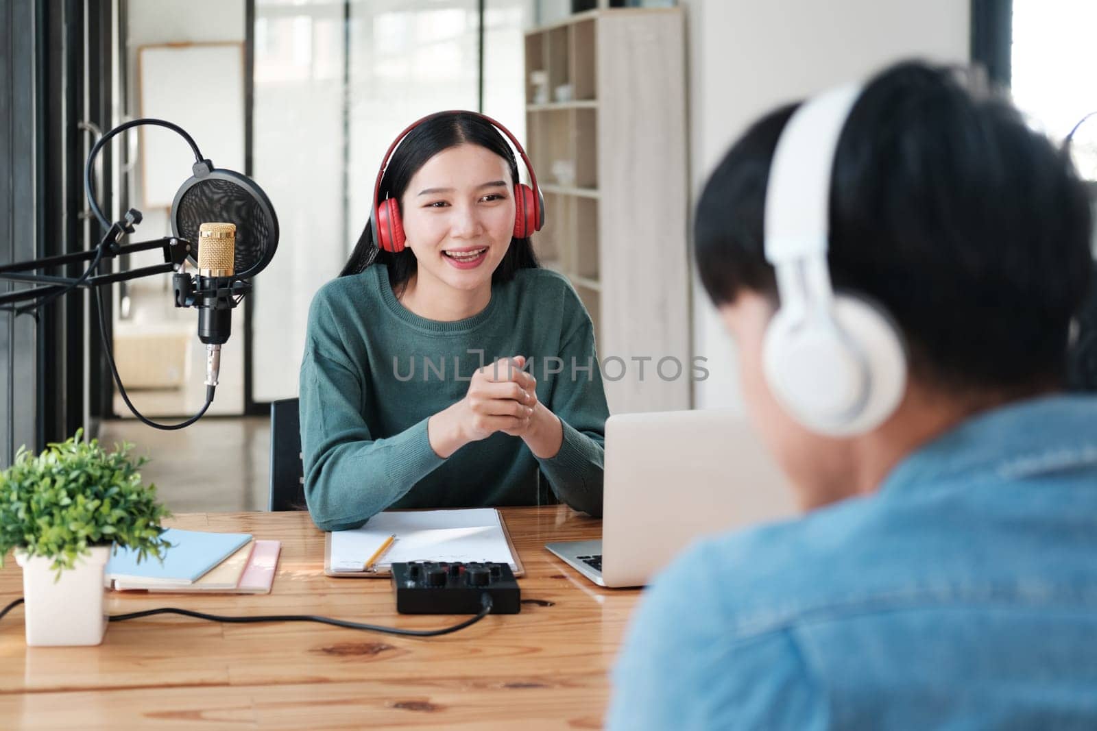 A woman is talking to a man in a studio by ijeab