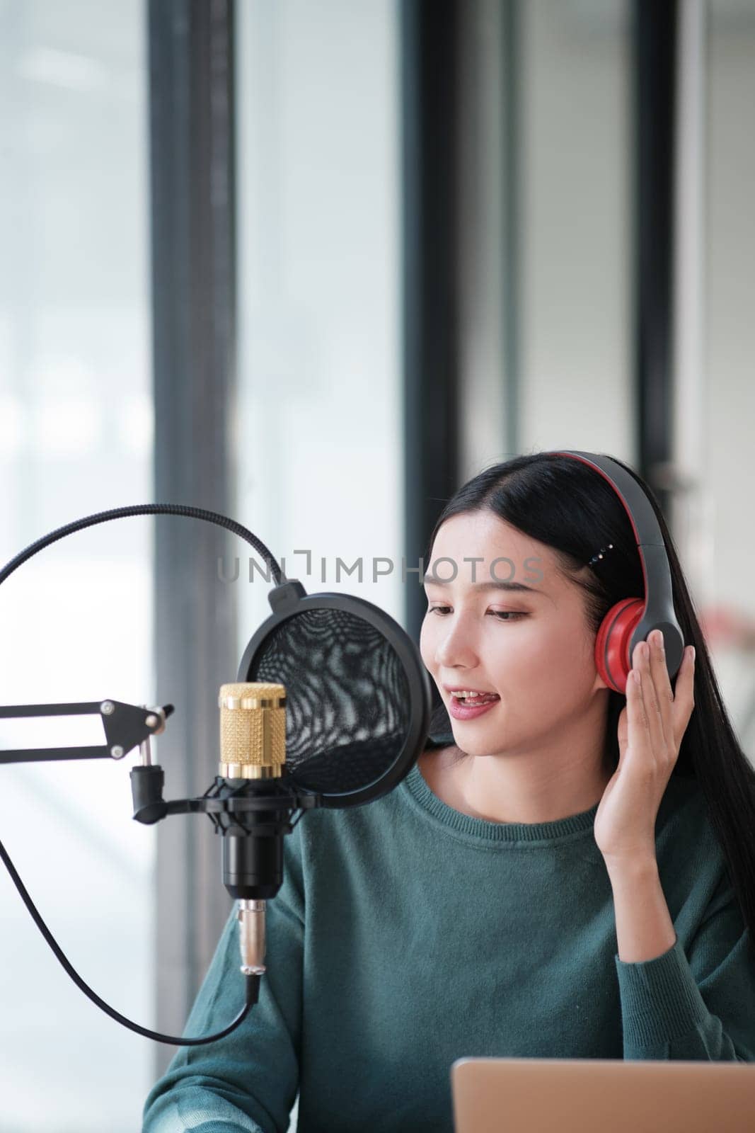A woman is recording a song in a studio by ijeab