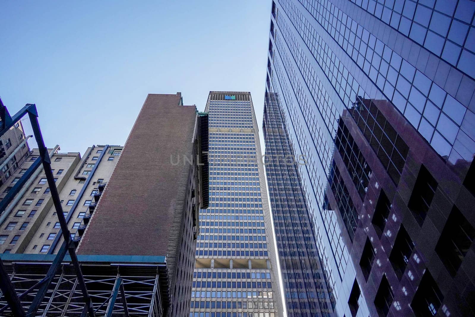 new york city manhattan skyscrapers view from the street to the top of the building on sunny clear day