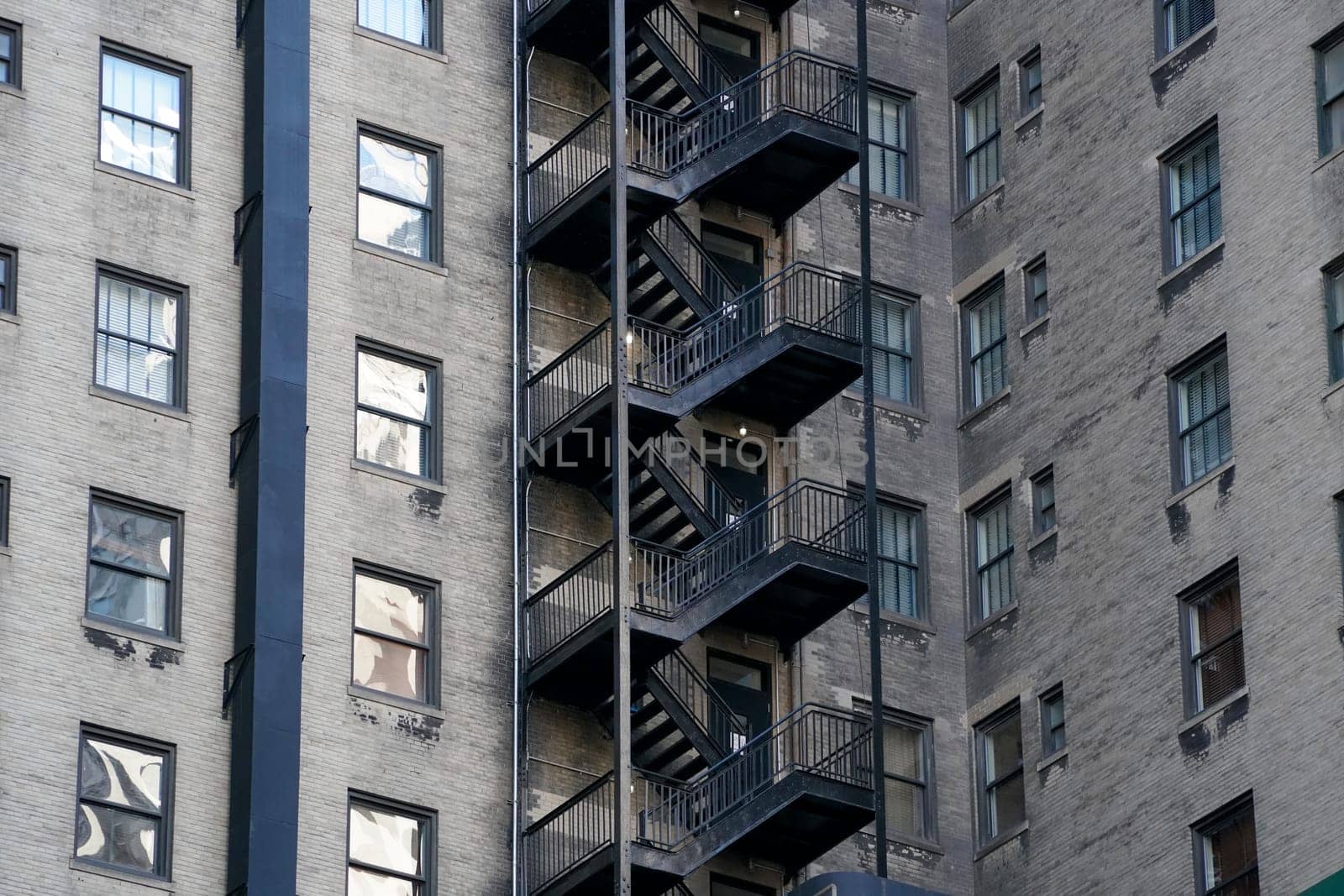 new york manhattan skyscrapers view from the street to the top of the building on sunny clear day by AndreaIzzotti