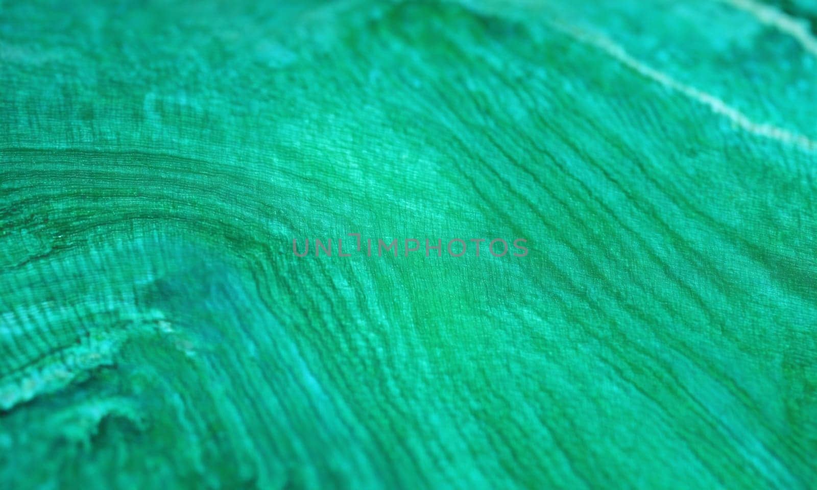 Emerald green natural stone texture background. Close up of emerald gemstone.