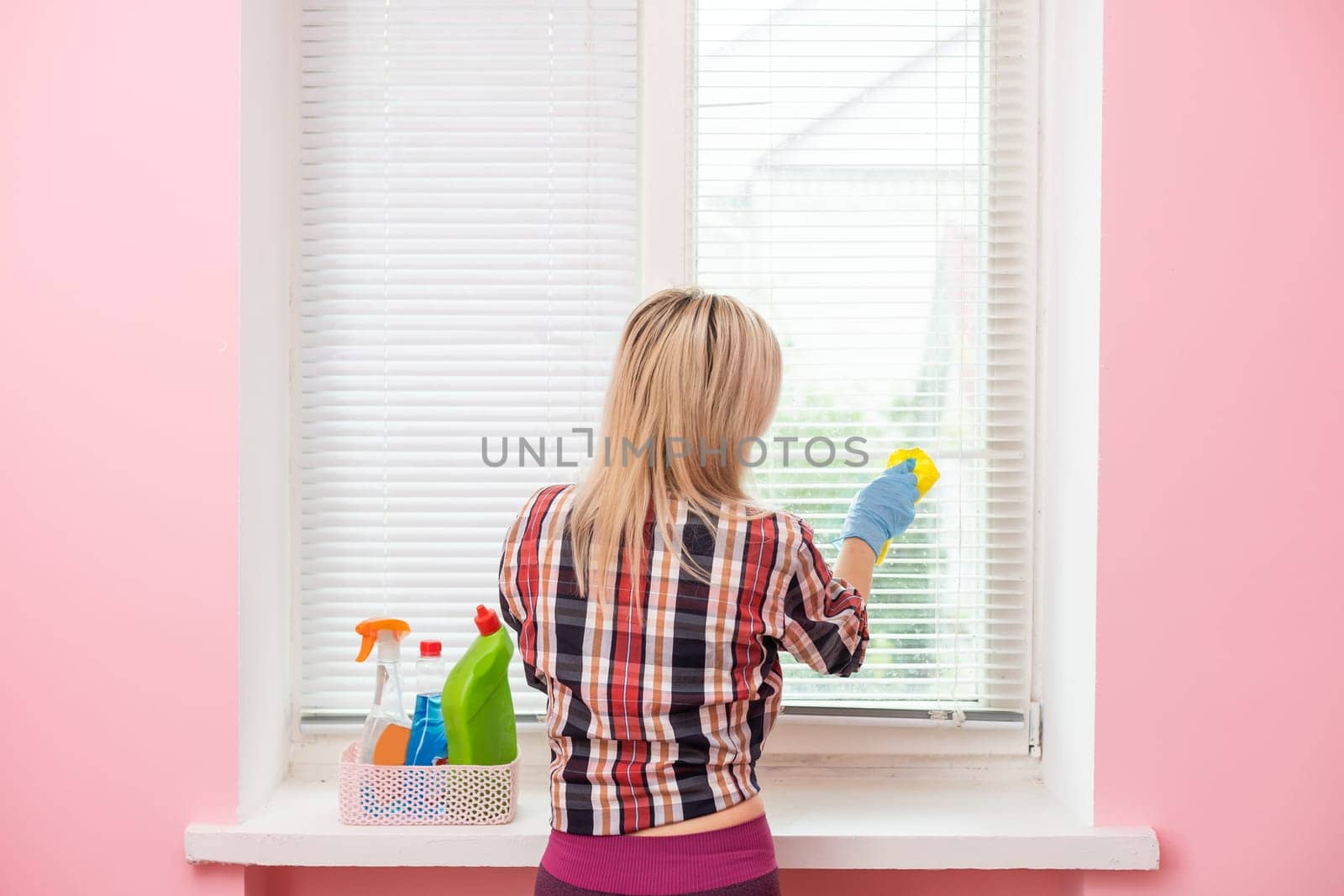 Woman cleaning and polishing with a spray detergent, housekeeping and hygiene concept.