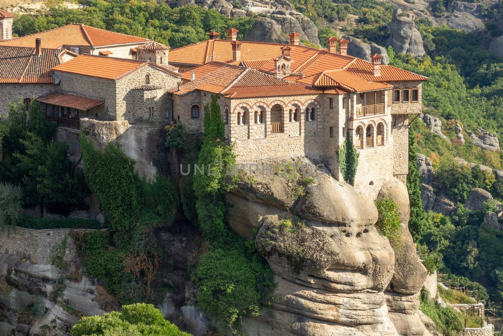 Greece. Sunny summer day in Kalambaka. Rock monastery with red roofs