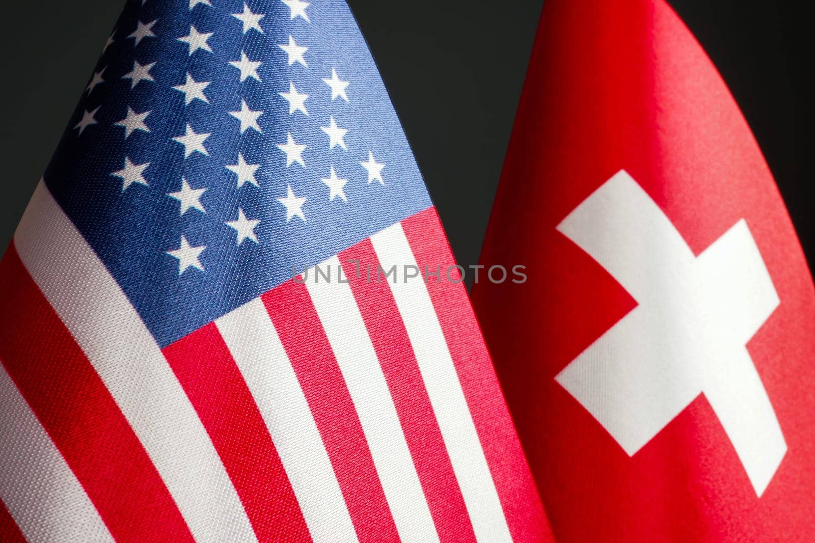 Nearby are the small flags of the USA and Switzerland.