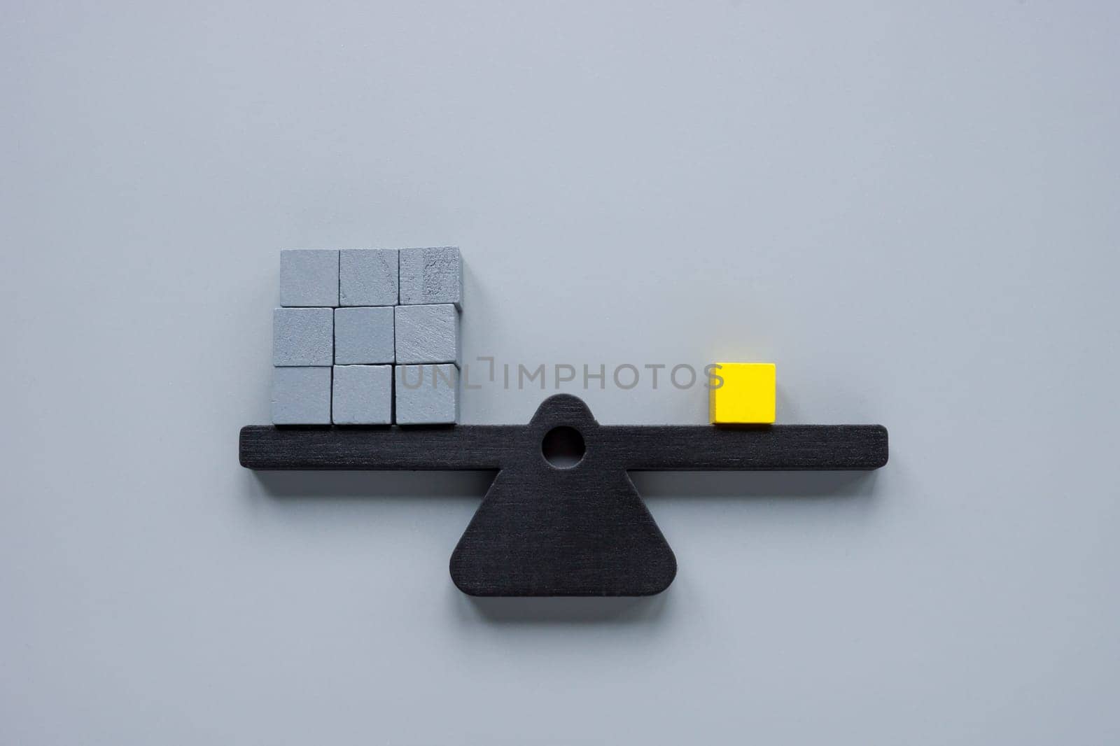 Scales with gray cubes and one yellow one. Be different, unique concept.