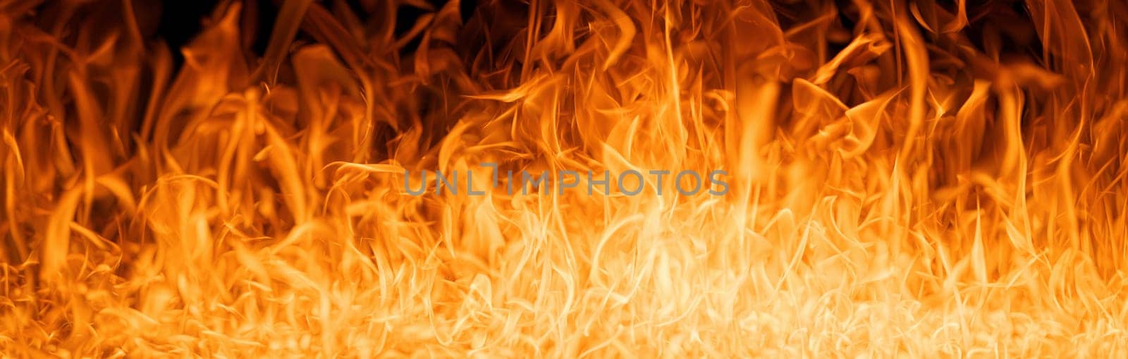 Hell flames, devil's mouth. fire banner. A background of scalding flames. Firestorm. Fire burning. Bright burning flames on a black background. Wall of Real fire, abstract background. Fire flames.