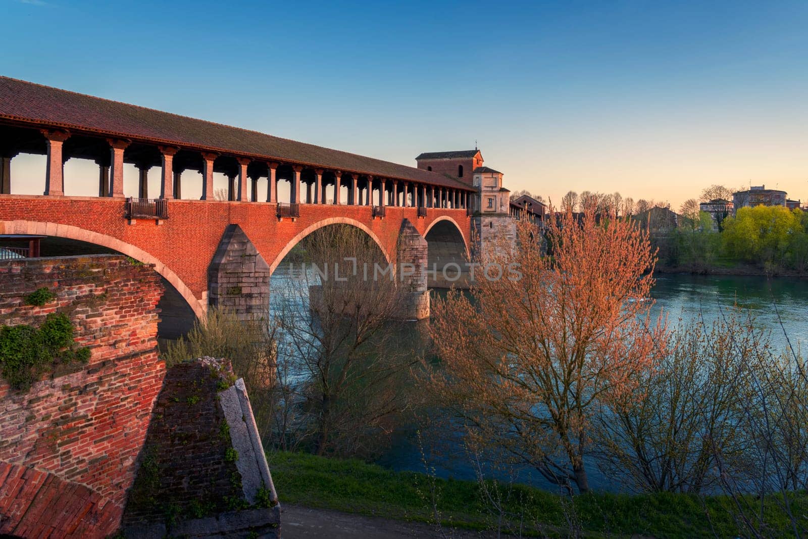 wonderful view of Ponte Coperto (covered bridge) is a bridge over the Ticino river in Pavia at sunset, Lombardy, Pavia, Italy