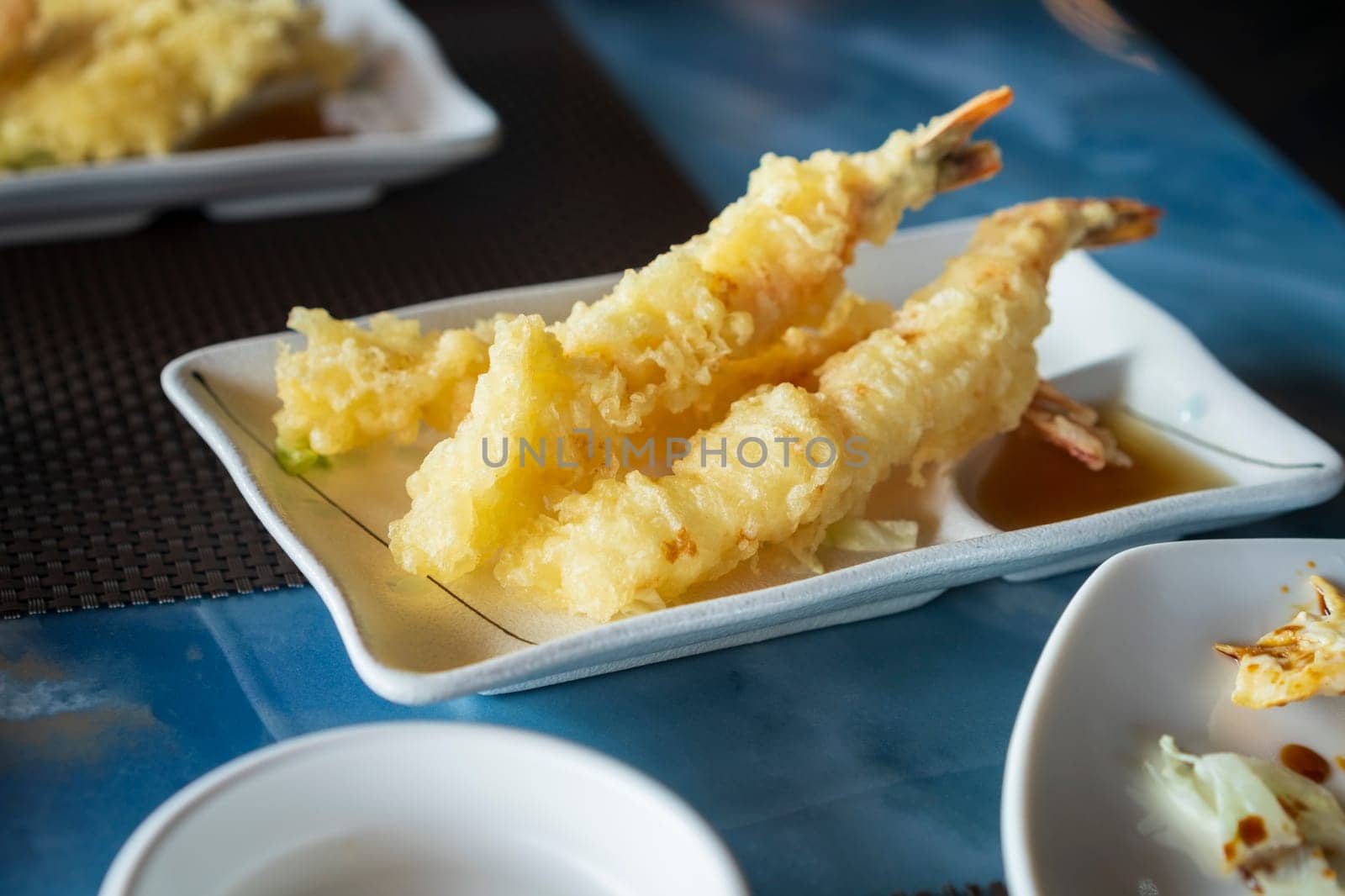 Nice view of prepared Japanese prawns tempura recipe with ginger ponzu sauce at restaurant