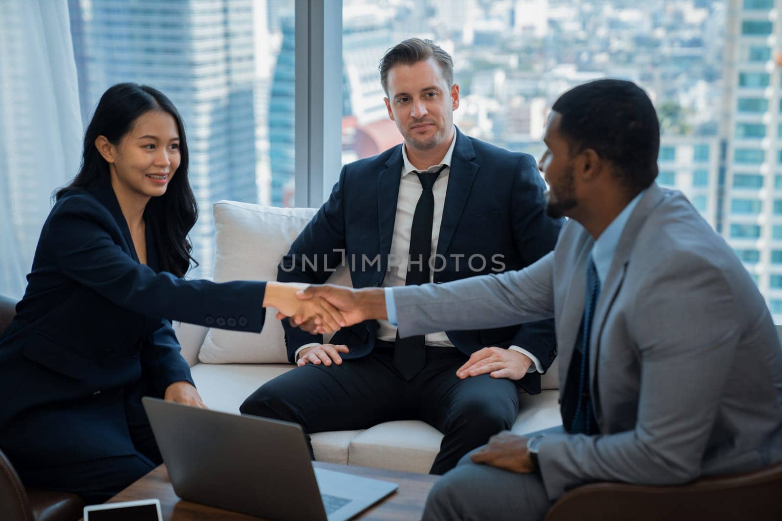 Portrait of young beautiful business shaking with african businessman at office. Businessman making handshaking representing unity, partnership, corporation, joining, collaboration. Ornamented.