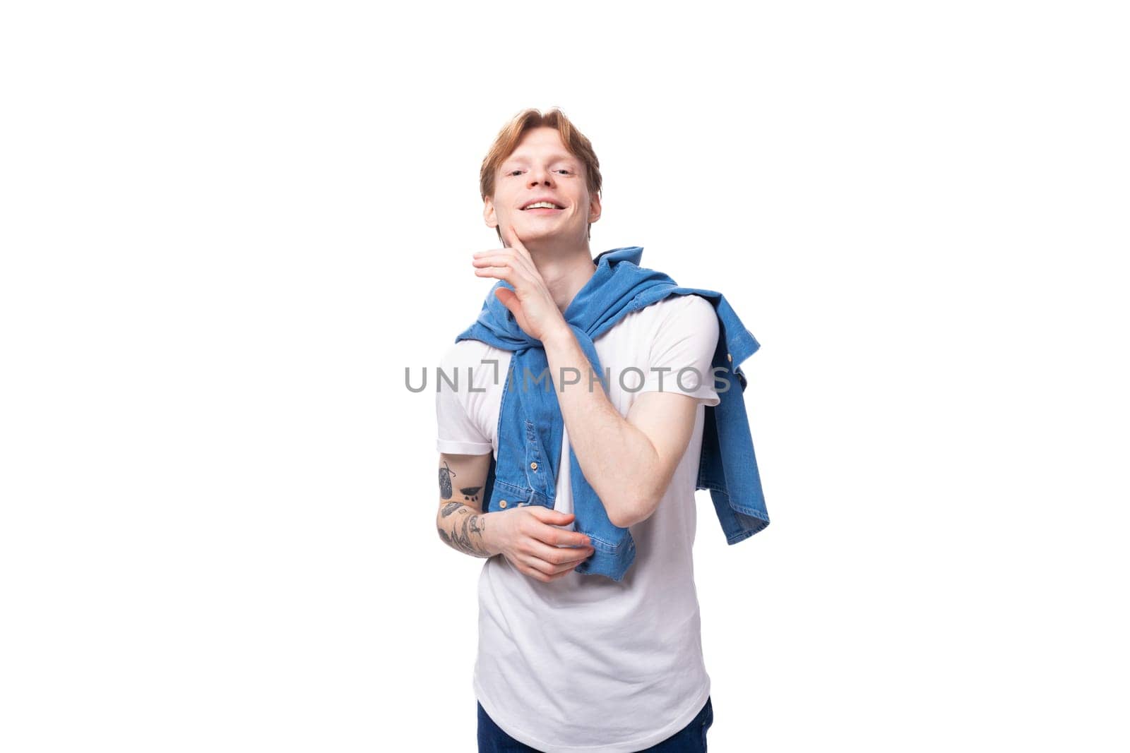 young friendly handsome european man with red hair wears a blue denim shirt over a white t-shirt. people clothes concept by TRMK