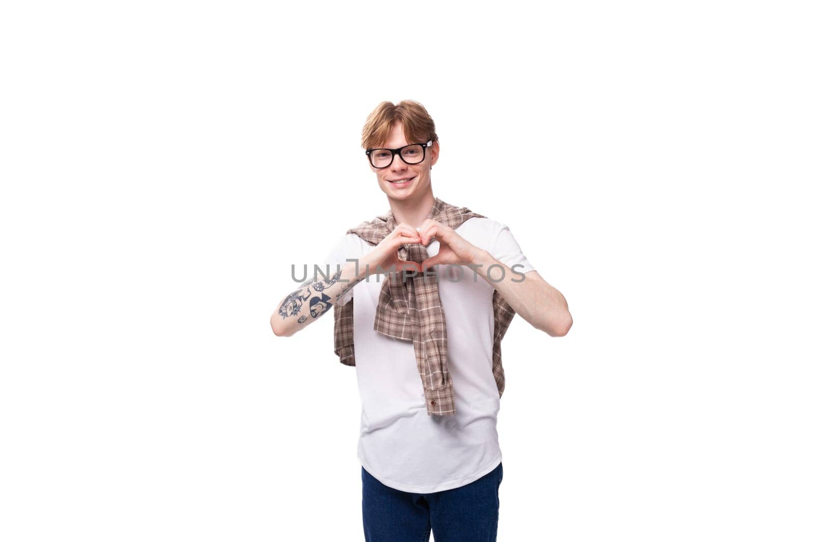young friendly man with red hair shows heart gesture by TRMK