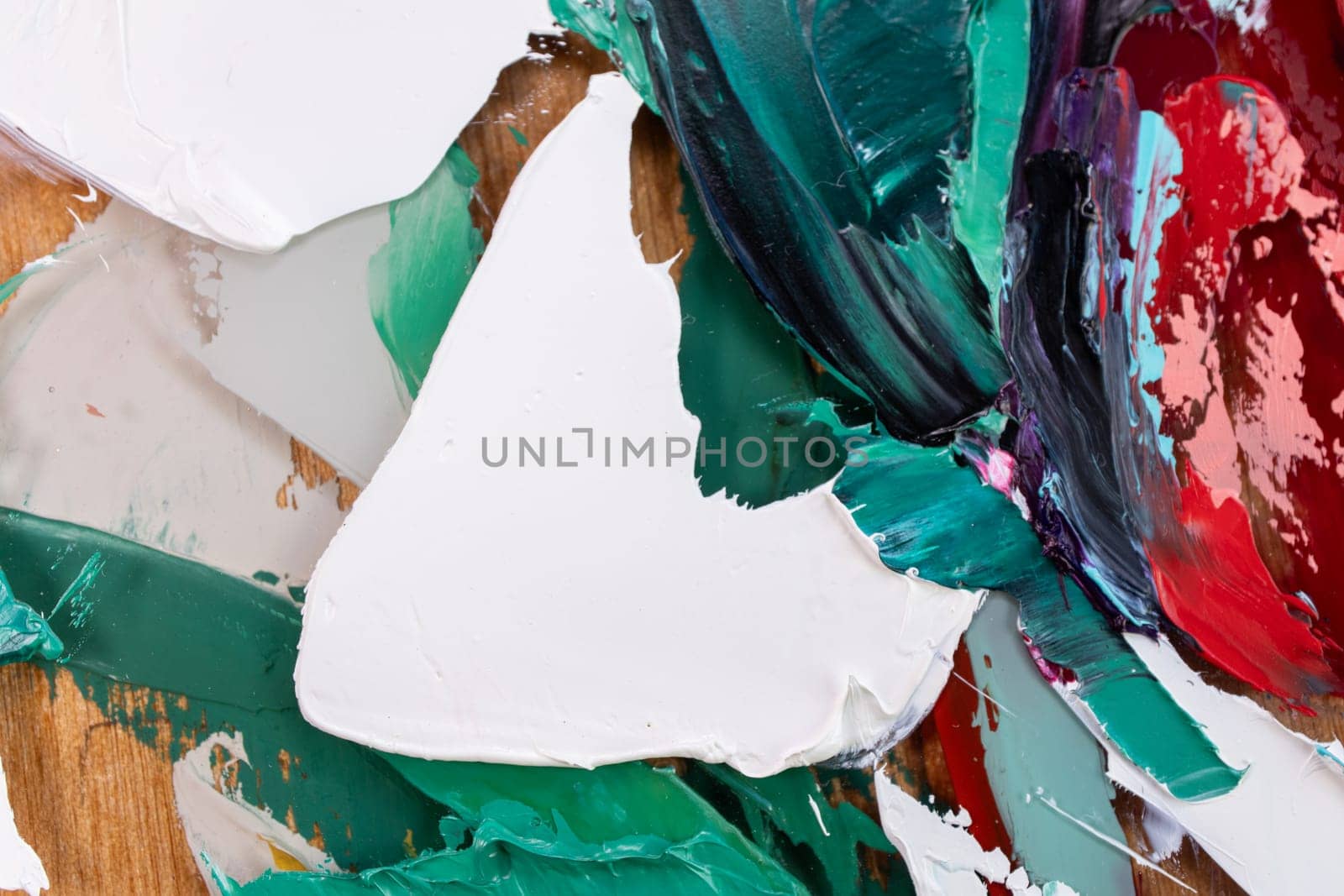 Fragment of multicolored texture painting on plywood. Abstract art background. oil on canvas. Rough brushstrokes of paint. Closeup of a painting by oil and palette knife. Highly-textured, high quality details.