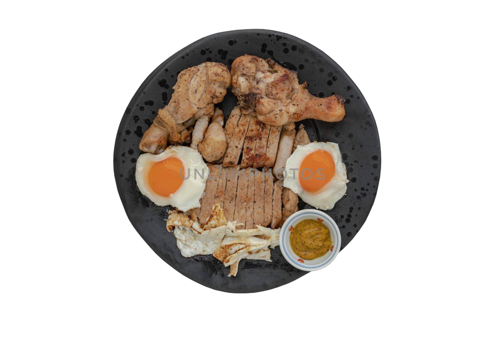 Pork steak, Fried chicken drumsticks and Fried eggs for dinner are served with dipping sauce on ceramic plate isolated on white background with clipping path. A plate of favorite food, Top view, Space for text, Selective Focus.