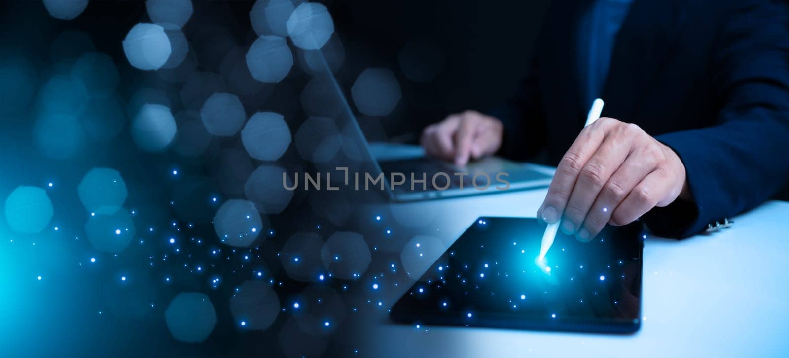 Businessman holds pen and points at tablet indicates the start of work and business connections