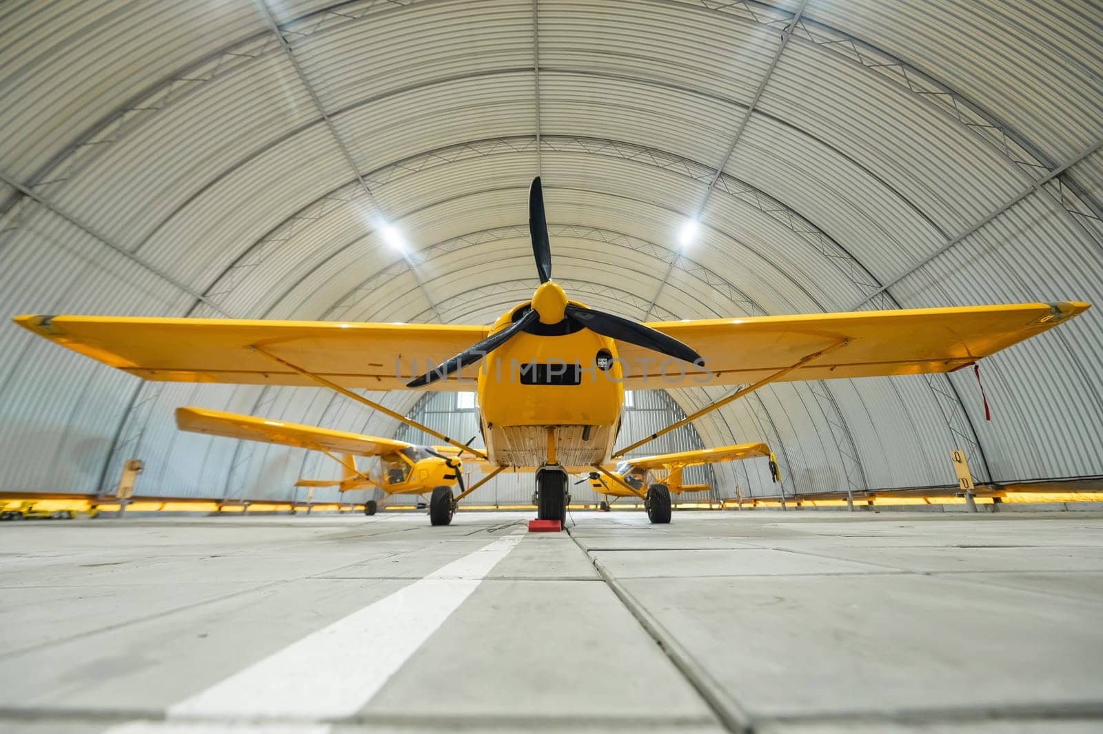 Yellow airplane glider in the hangar. by mrwed54