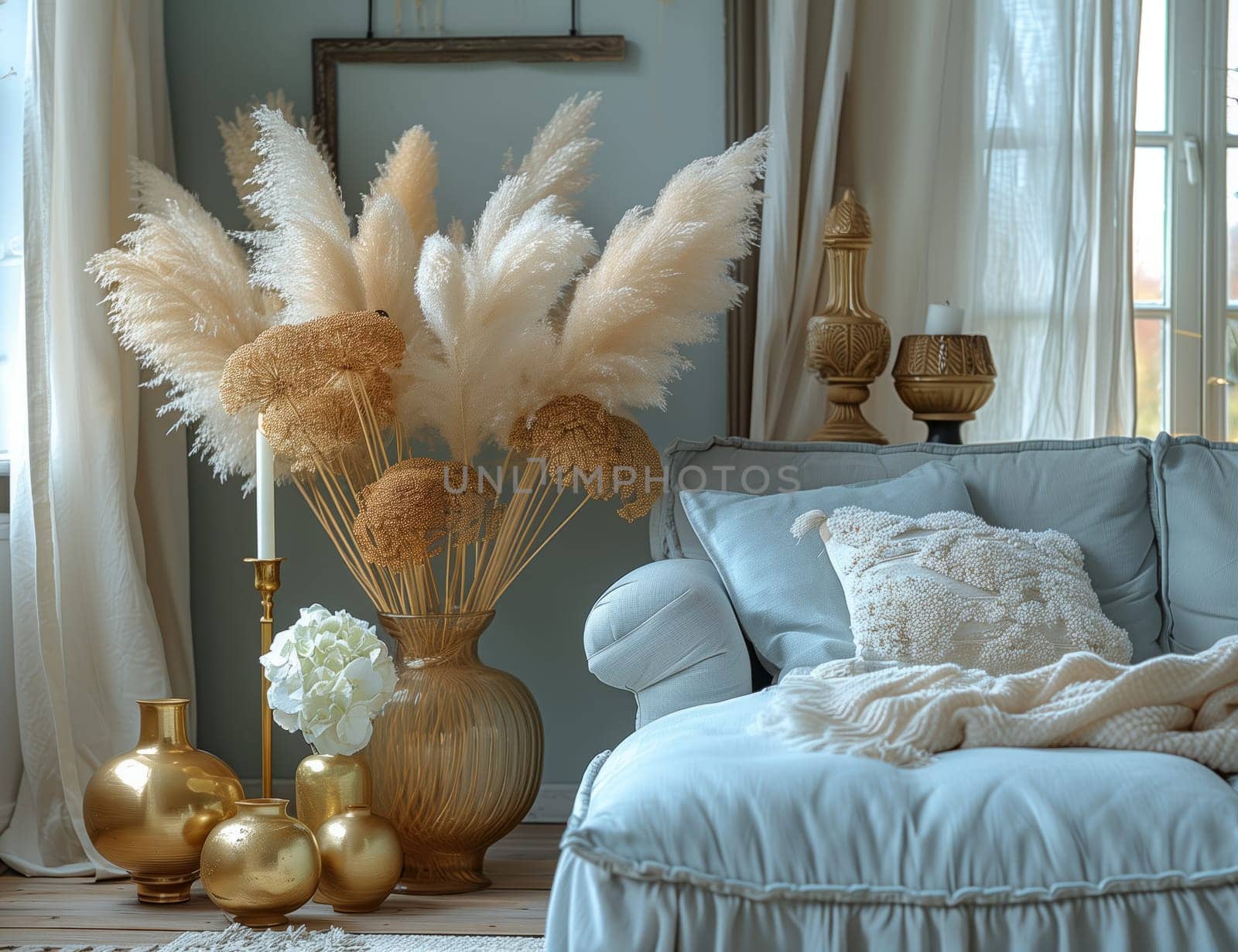 A cozy living room in a house with a comfortable couch, artful vases, flickering candles, and elegant pampas grass. Wooden accents and pillows add warmth to the space
