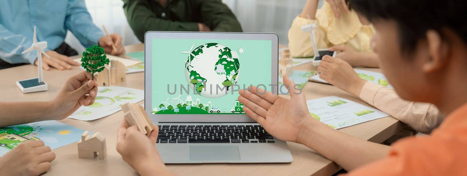 Green city logo displayed on a laptop at a green business meeting. Delineation by biancoblue