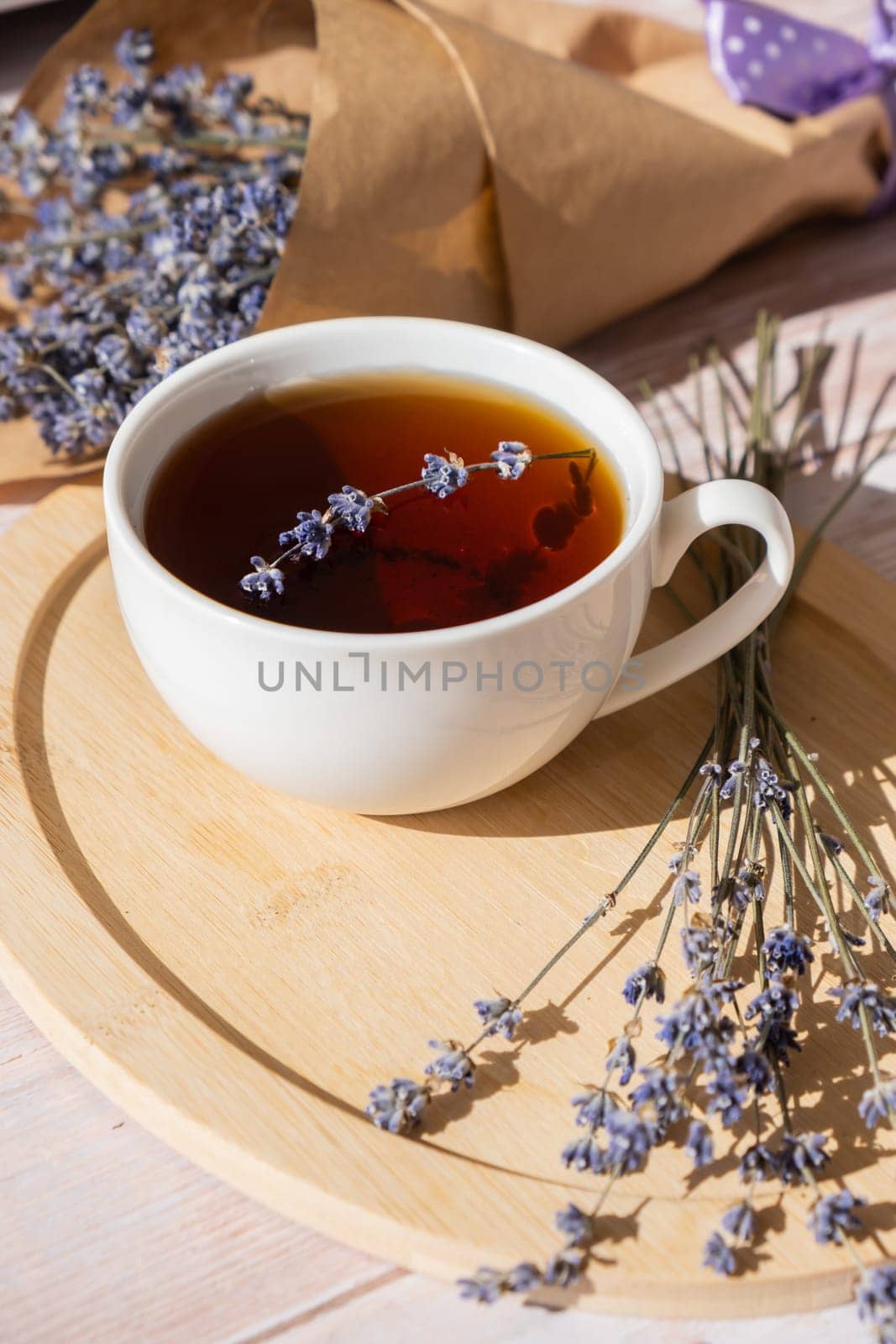 Healthy homemade cup of lavender tea. Organic natural home grown herb for teas. White cup of tea with dried lavender flowers. Healthy living wellbeing self care