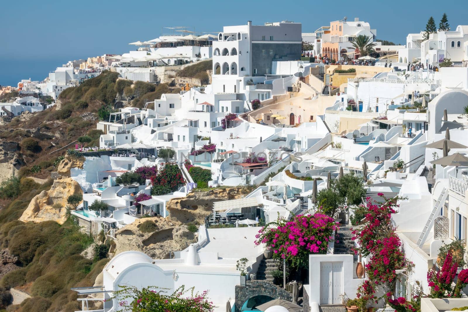 Greece. Sunny summer day in the Santorini caldera. White hotel buildings on the terraces of Oia