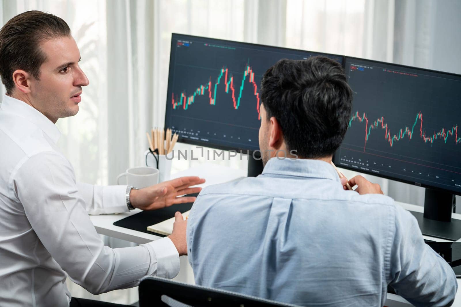Investor stock office worker analyzing investment business trend on dynamic exchange rate database graph with monitor screen. Sharing information profit and loss in current situation crisis. Sellable.