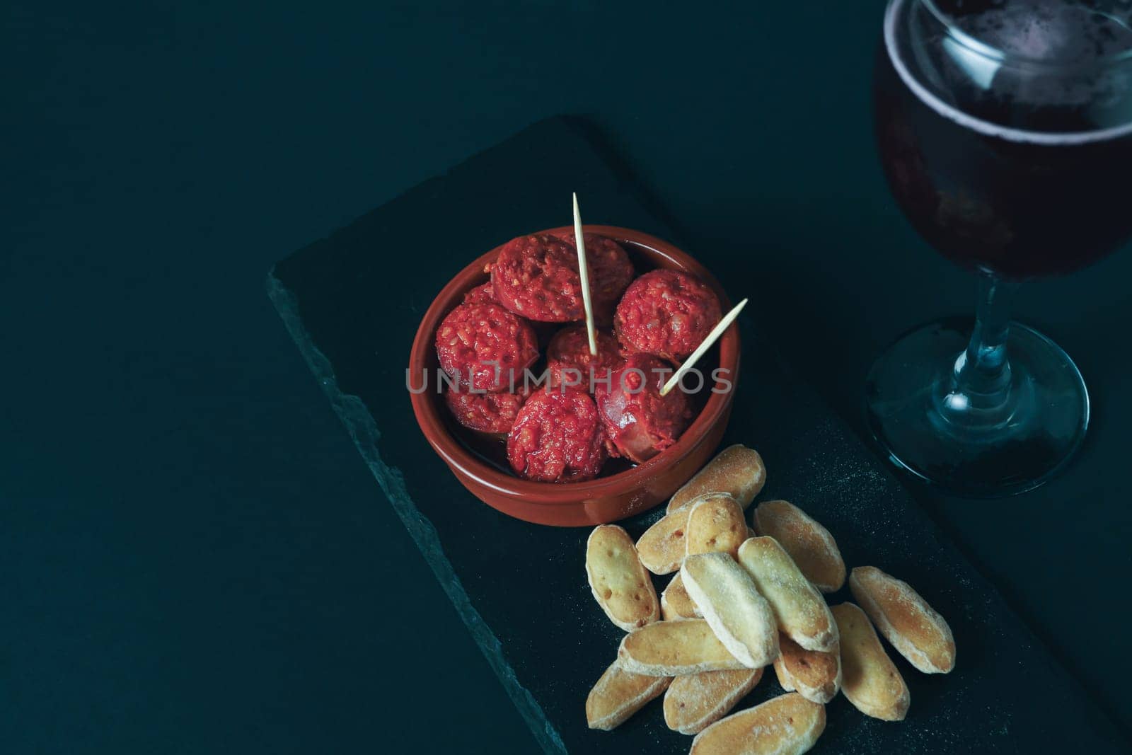 Traditional Spanish Tapas Served With Sangria on a Dark Table by joseantona