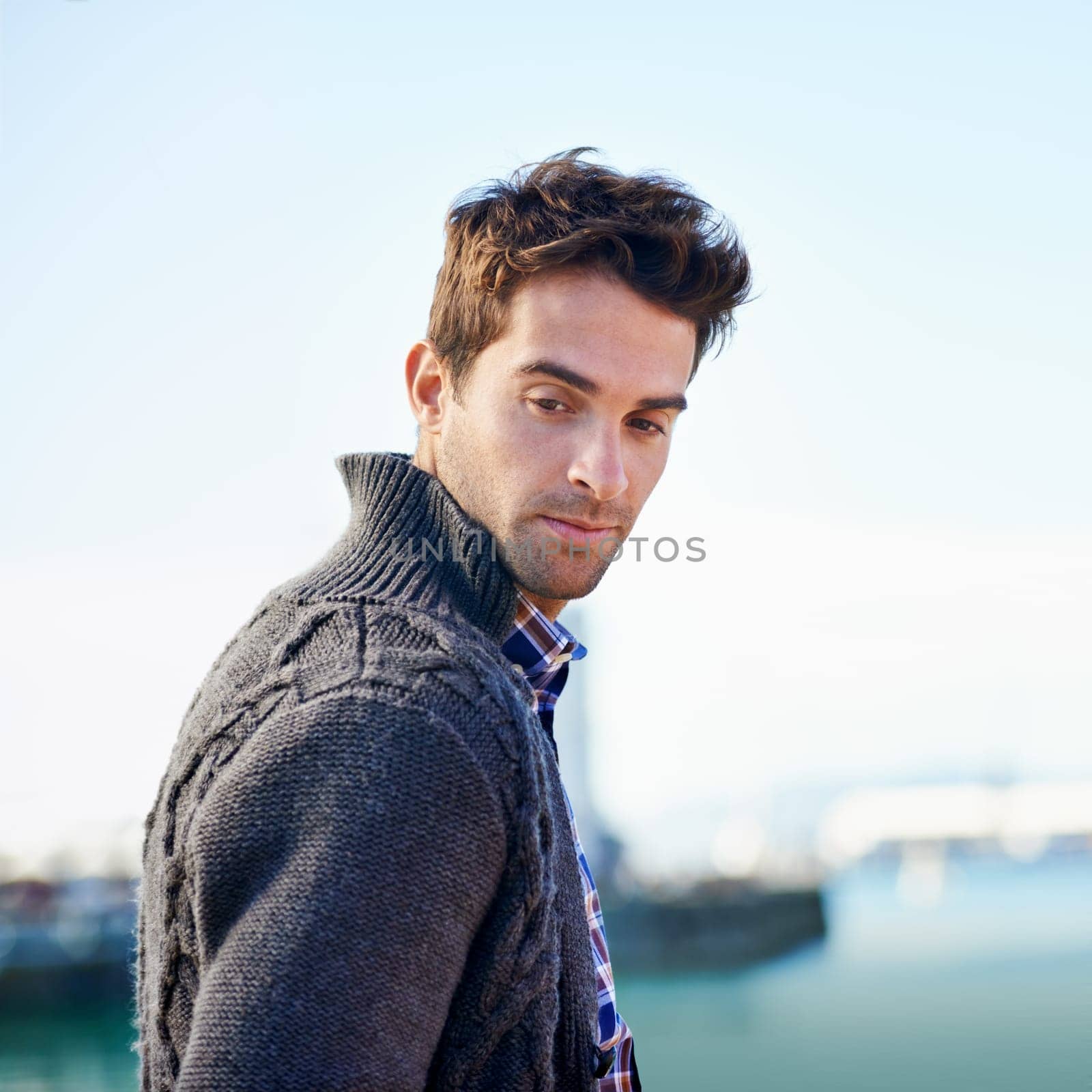 Ocean, outdoors and man with thinking in city for travel, journey or weekend commute in Canada. Confident, male person and serious face with idea for holiday, vacation or getaway trip by sea.