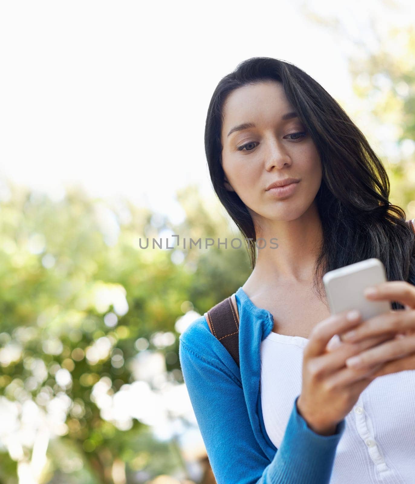 Woman, typing and outdoor with phone at college for social media and walking with communication in park. Online, chat and girl with virtual contact on smartphone, connection and networking in Paris.