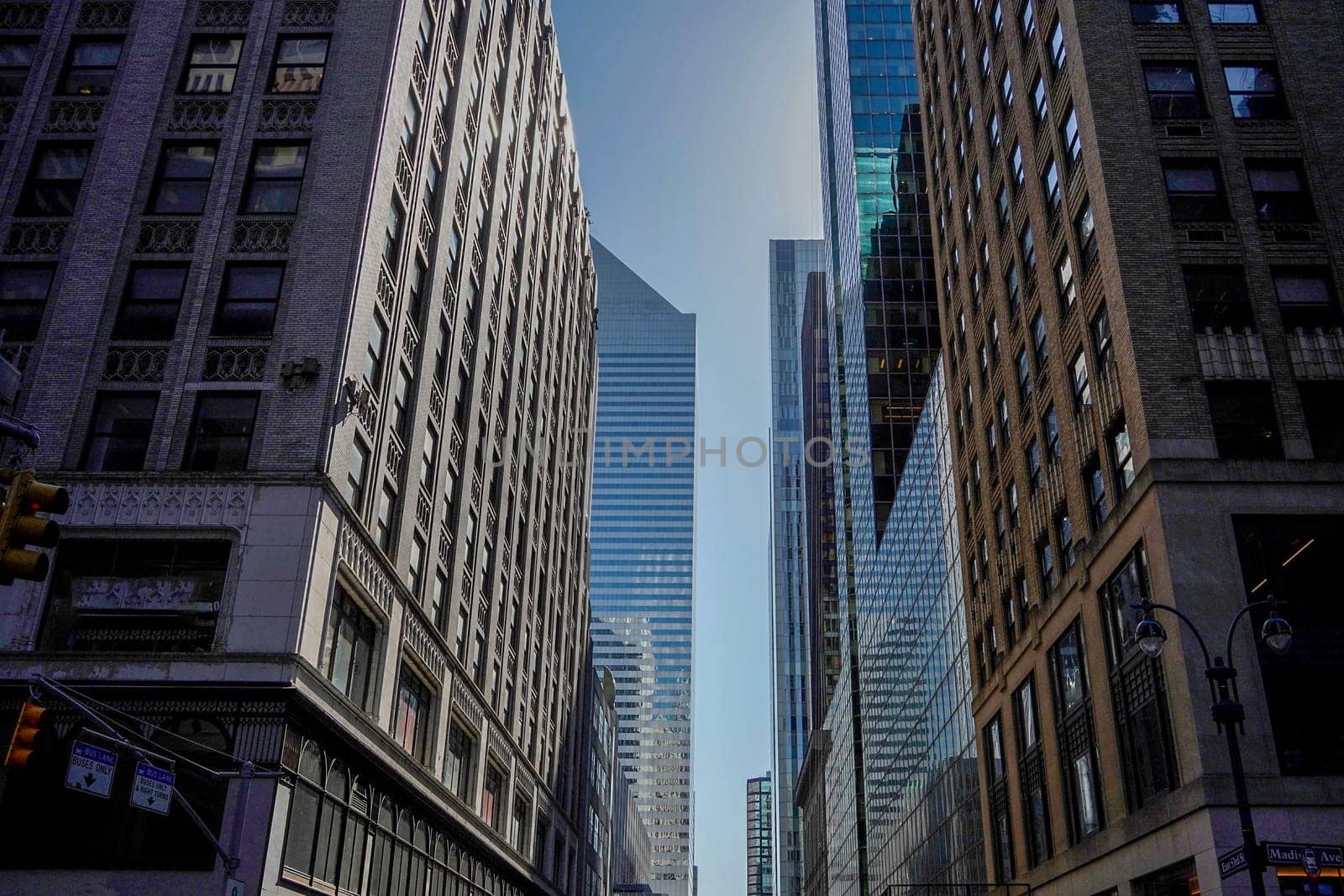 new york city manhattan skyscrapers view from the street to the top of the building on sunny clear day