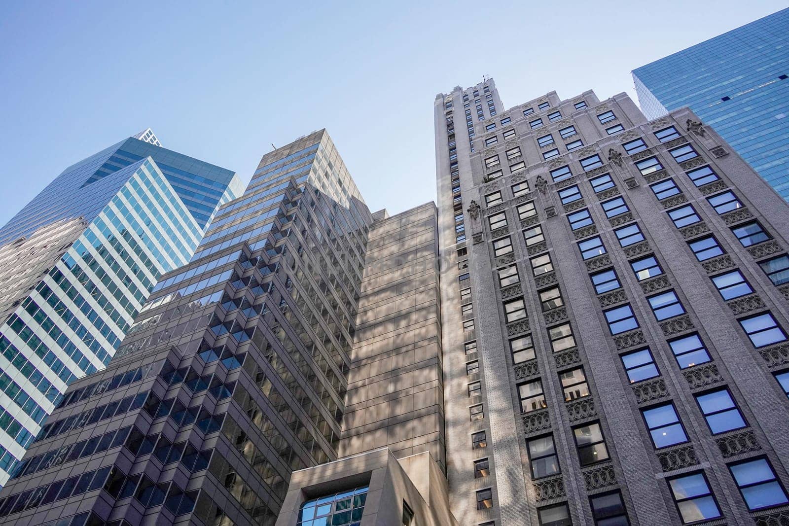 new york city manhattan skyscrapers view from the street to the top of the building on sunny clear day