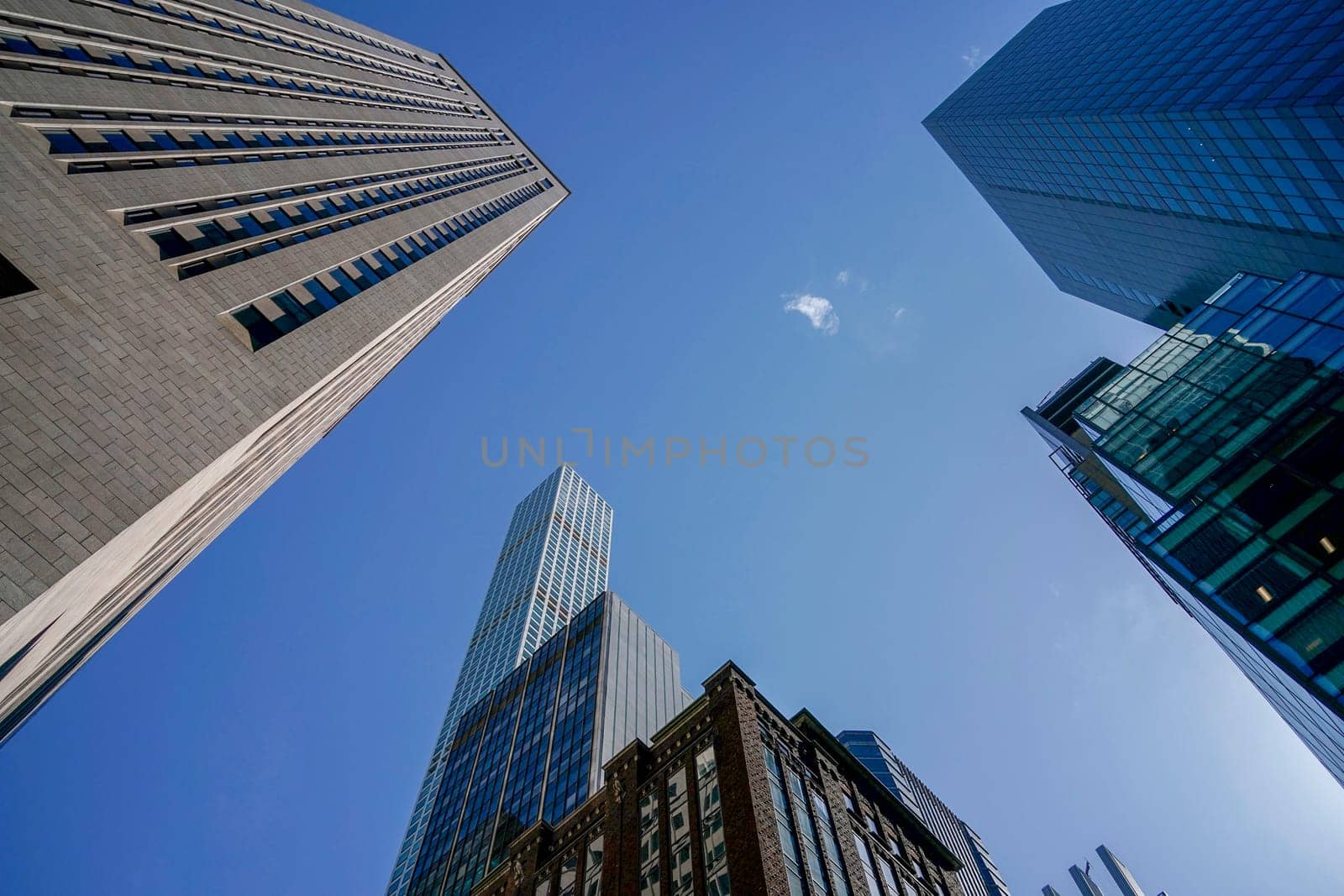 new york city manhattan skyscrapers view from the street to the top of the building on sunny clear day