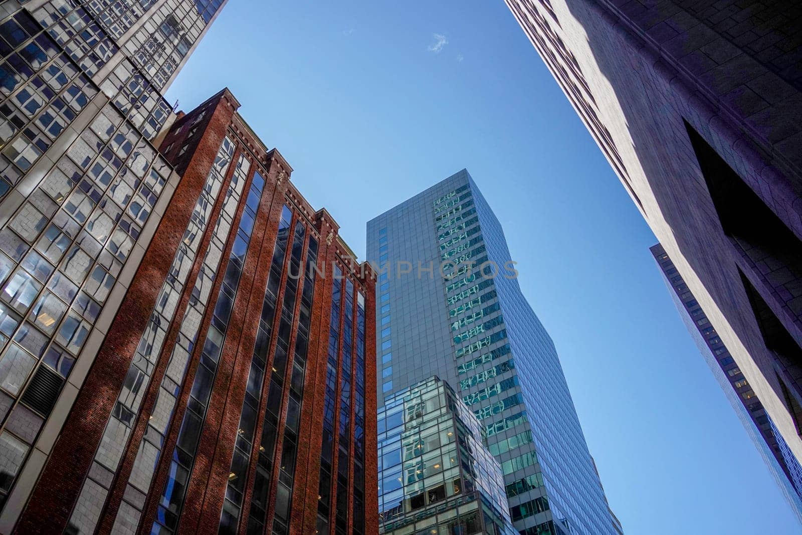 new york city manhattan skyscrapers view from the street to the top of the building on sunny clear day