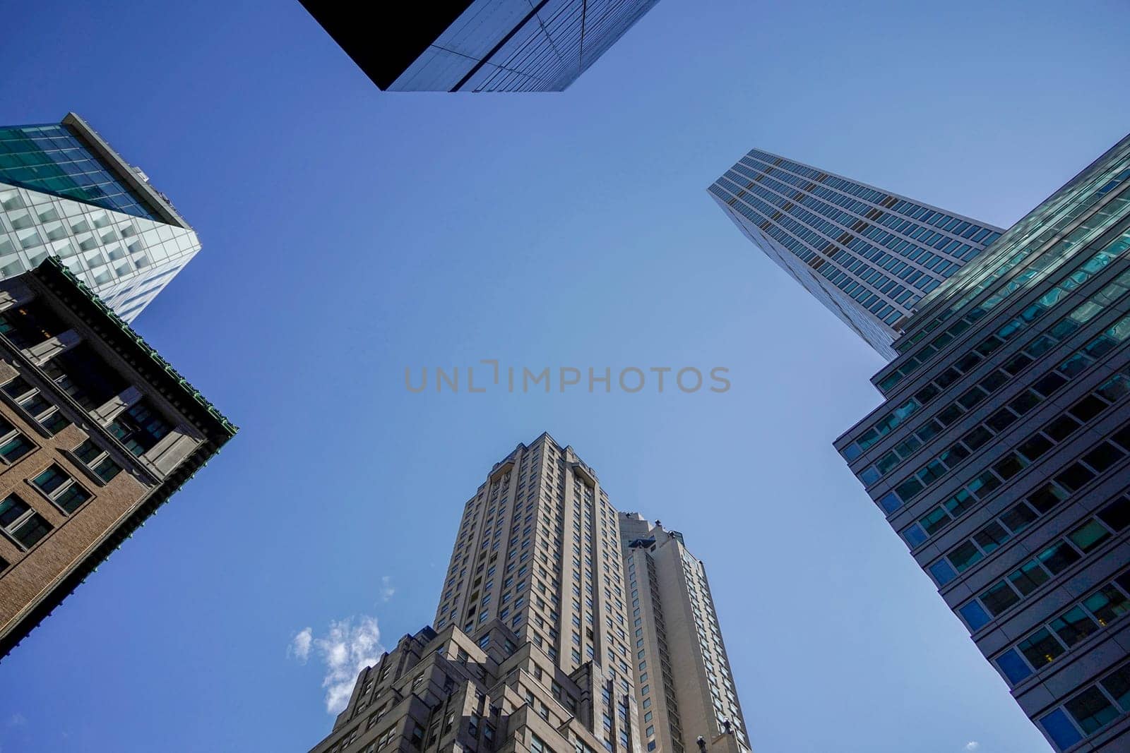 new york city manhattan skyscrapers view from the street to the top of the building on sunny clear day