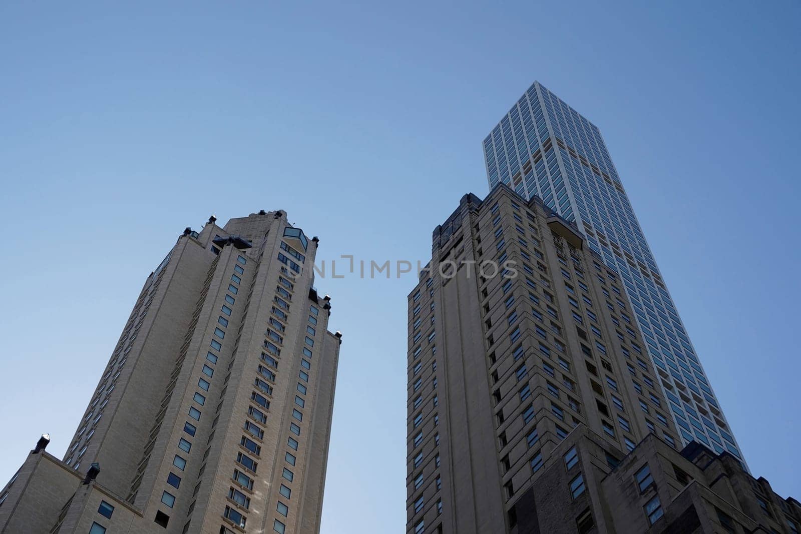 new york city manhattan skyscrapers view from the street to the top of the building on sunny clear day